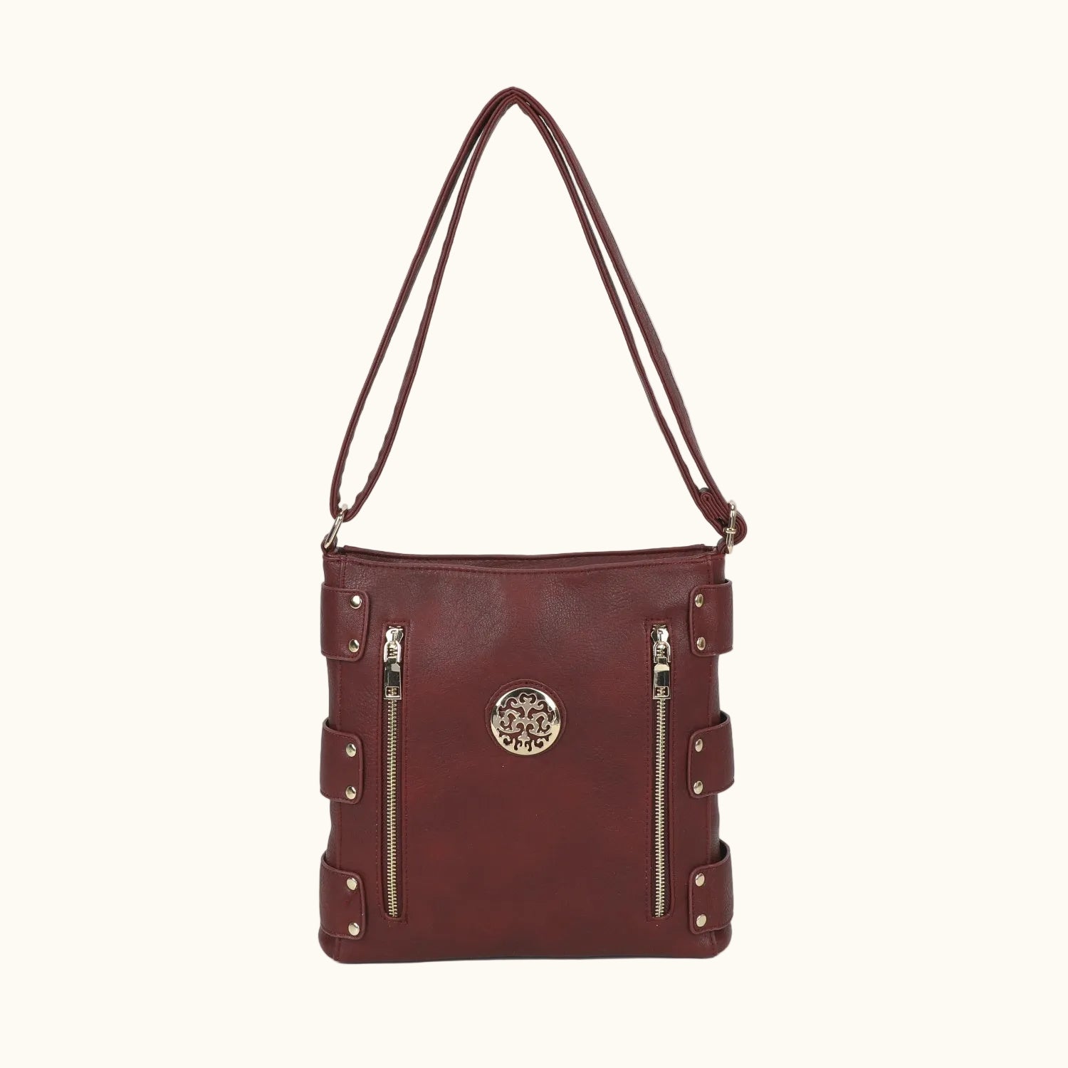 Brown leather handbag with gold zippers on a white background