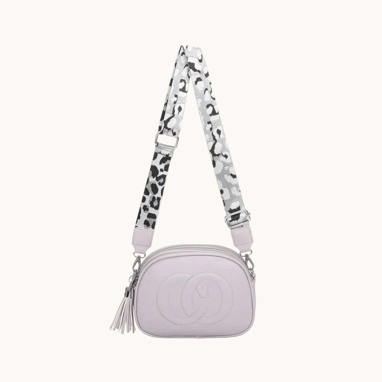 White handbag with a patterned strap on a white background