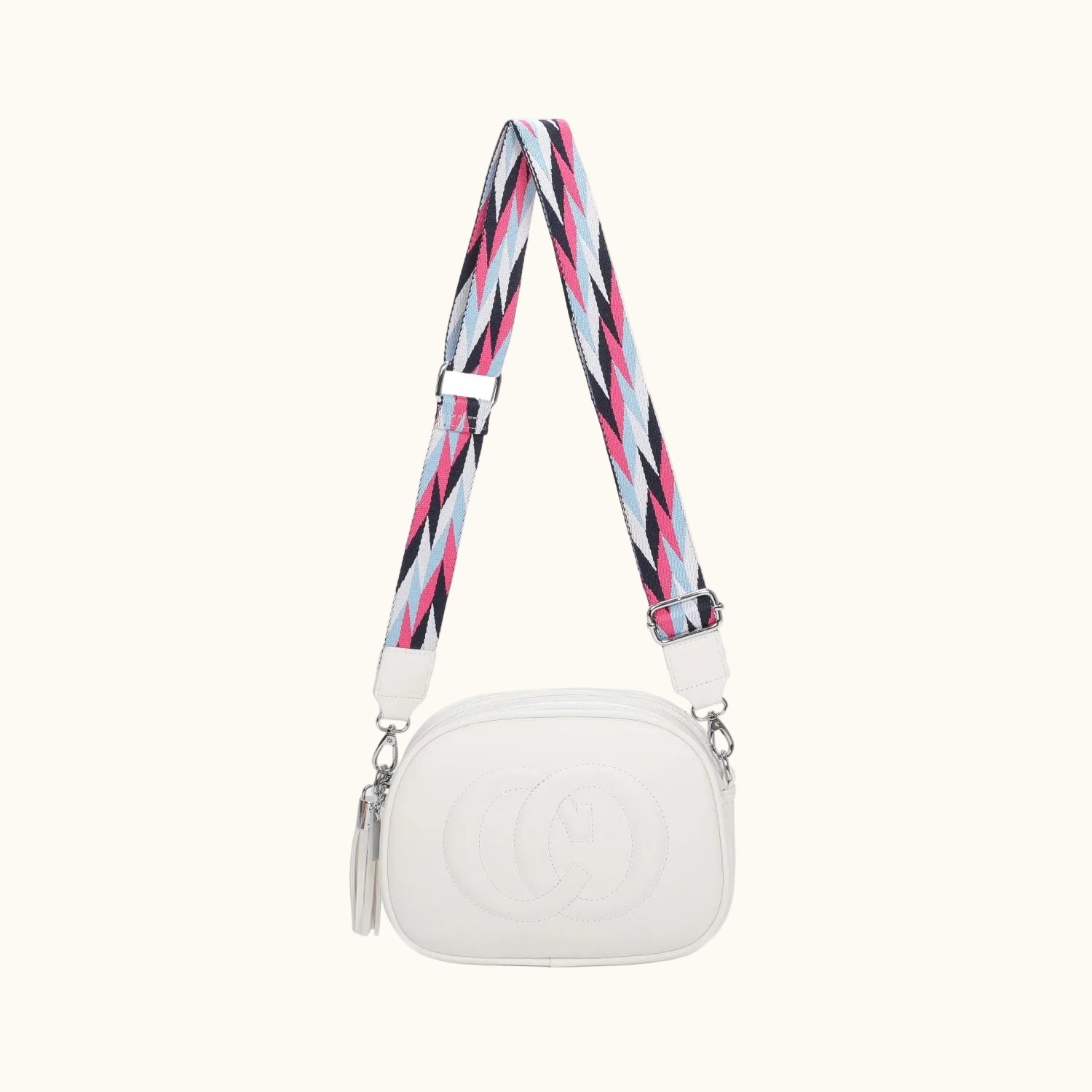 White handbag with a colorful strap on a white background