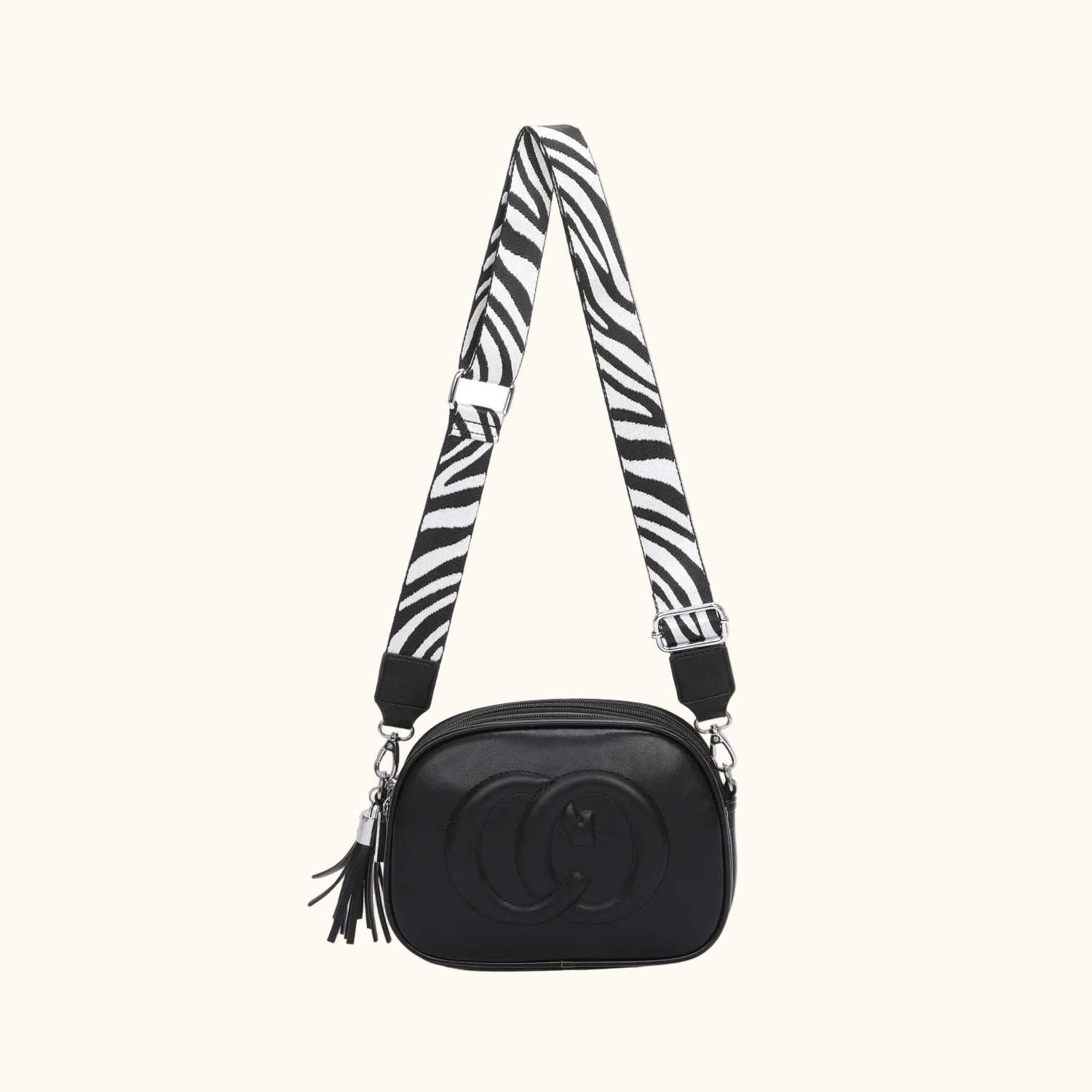 Black camera bag with a zebra-patterned strap on a white background