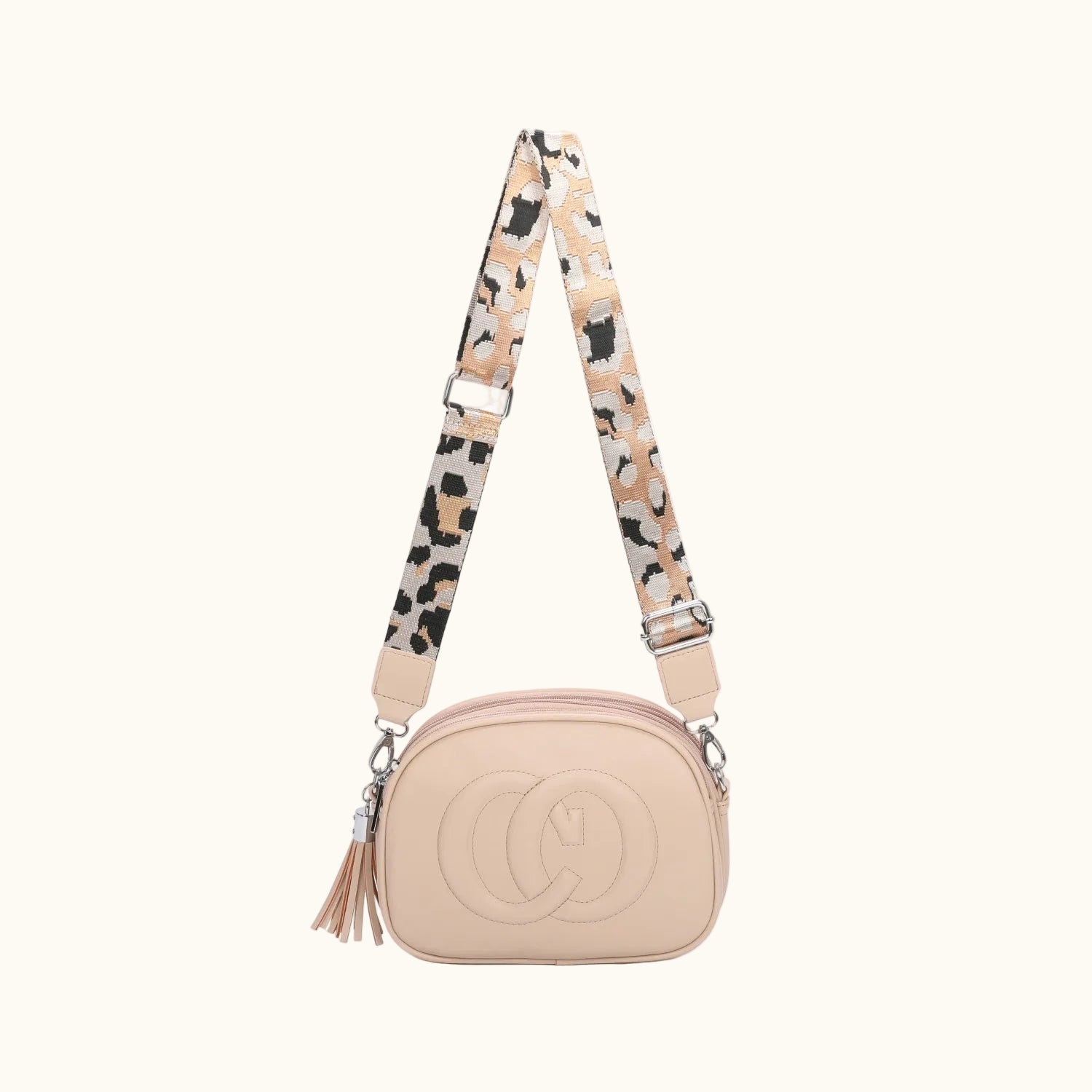 Beige handbag with a patterned strap on a white background