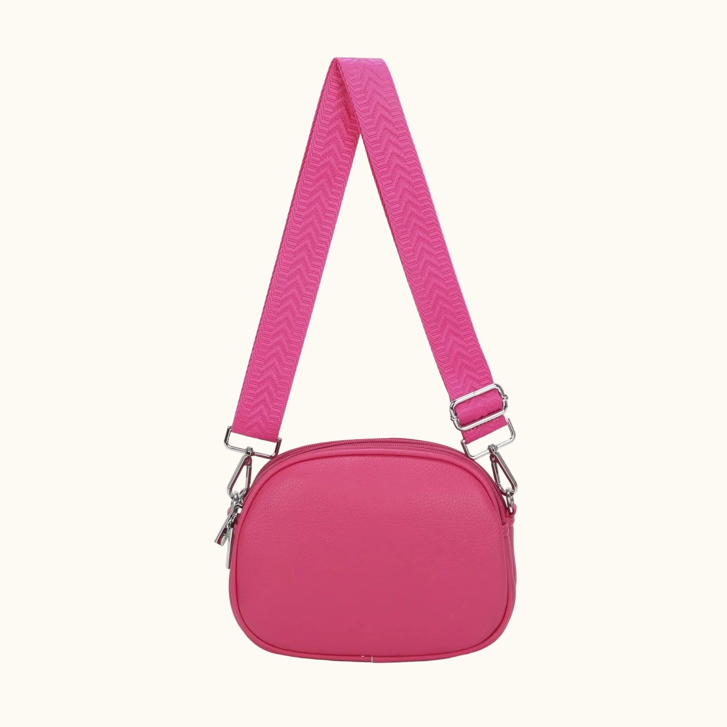 Pink crossbody bag with a strap on a white background
