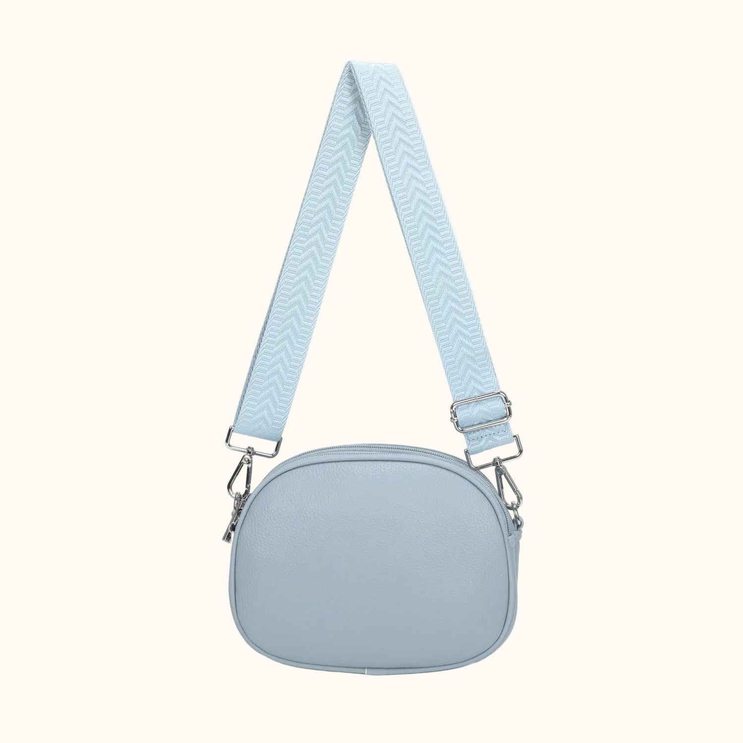 Light blue crossbody bag with a strap on a white background