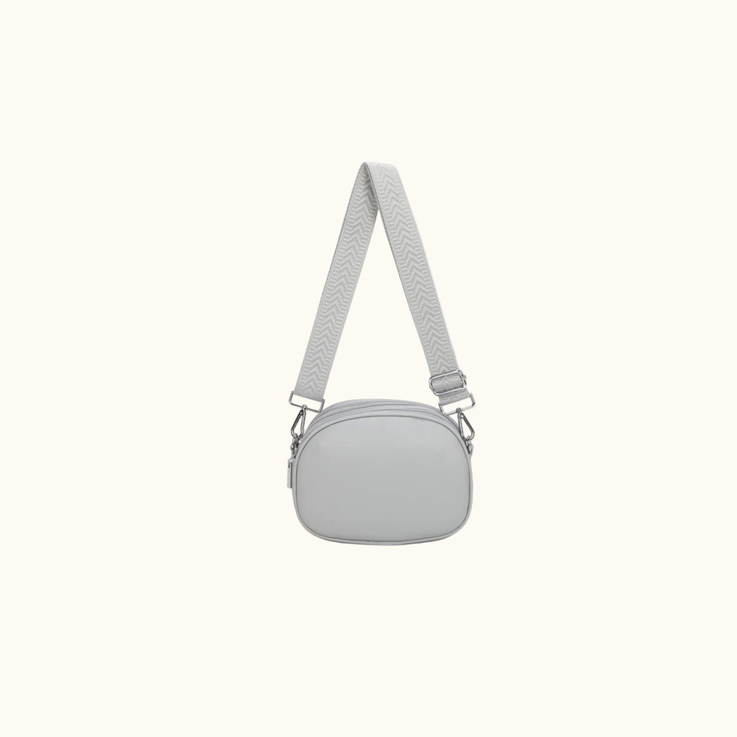 Gray crossbody bag with a strap on a white background