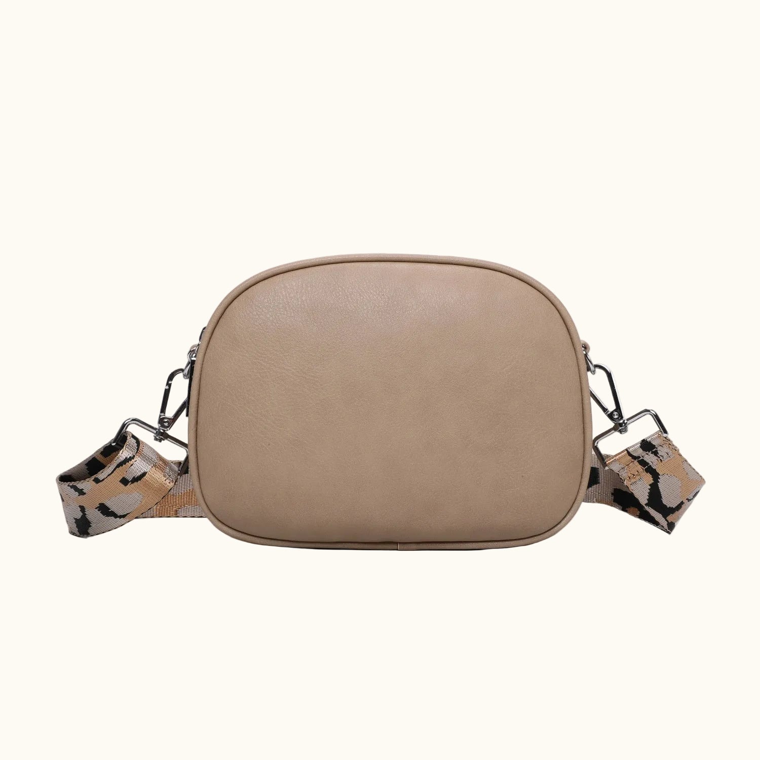 Beige crossbody bag with a patterned strap on a white background