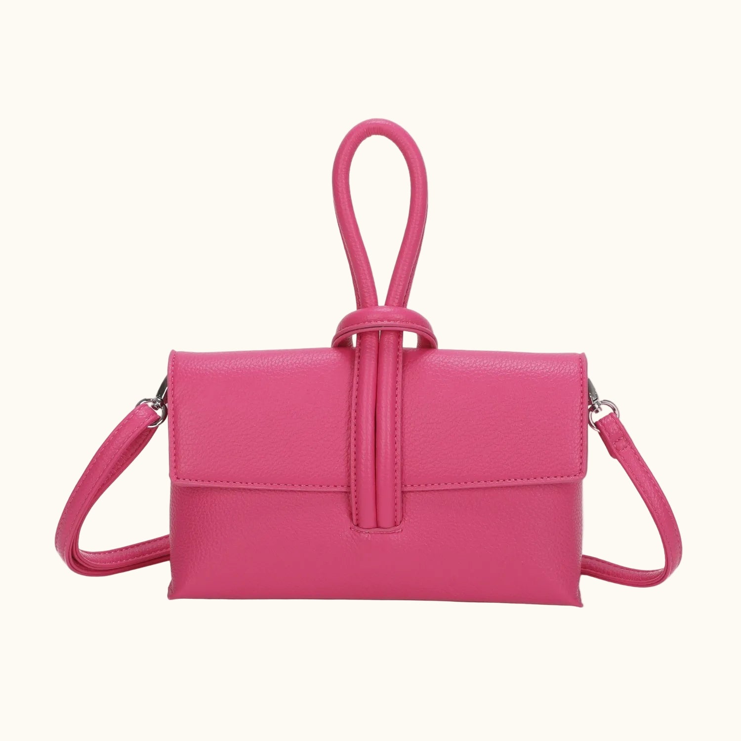 Pink handbag with a strap on a white background