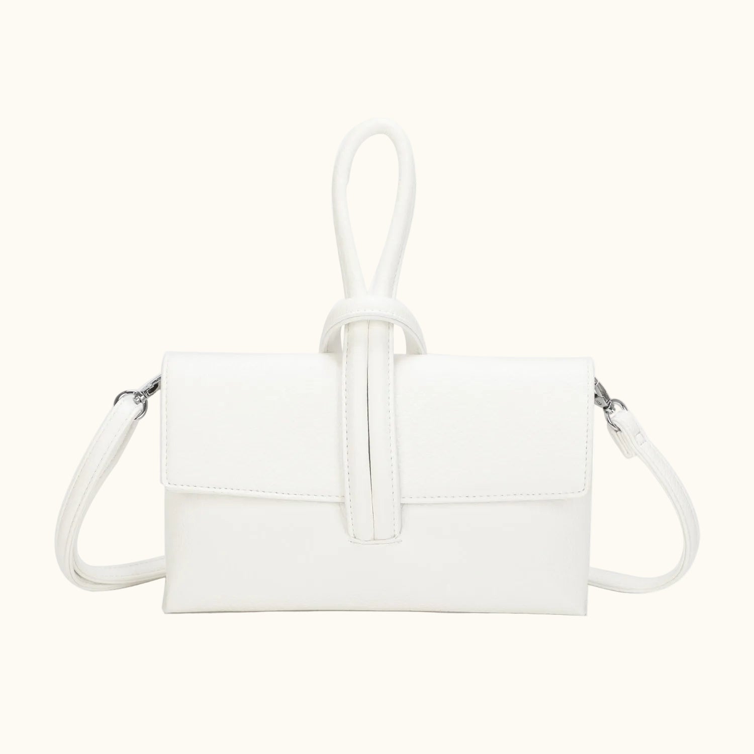 White handbag with a strap on a white background