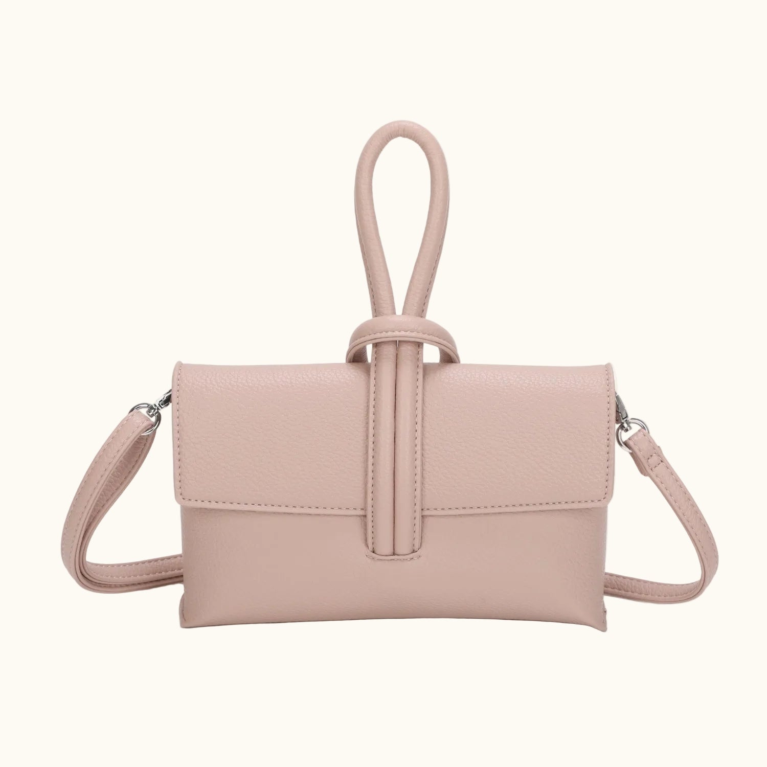 Pink handbag with a strap on a white background