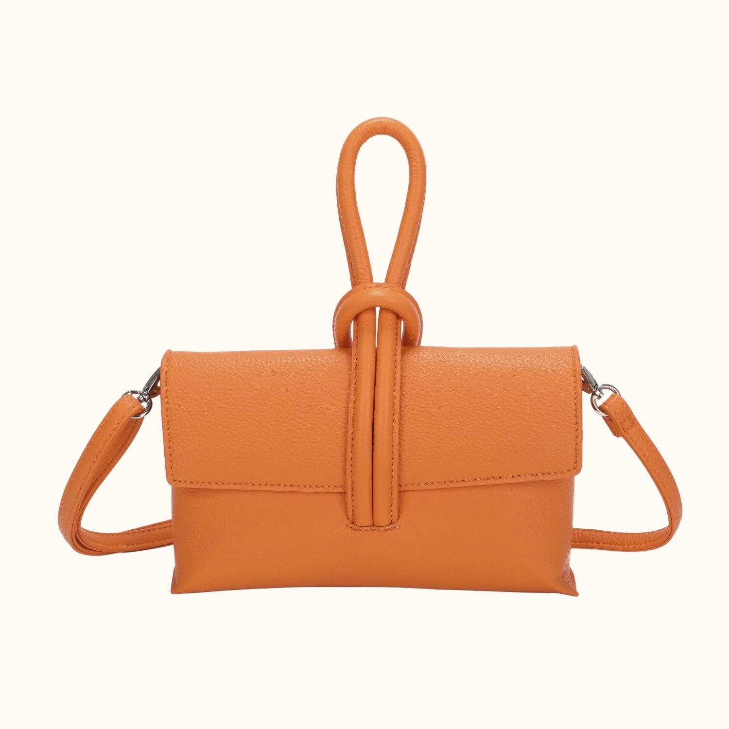 Orange handbag with a strap on a white background