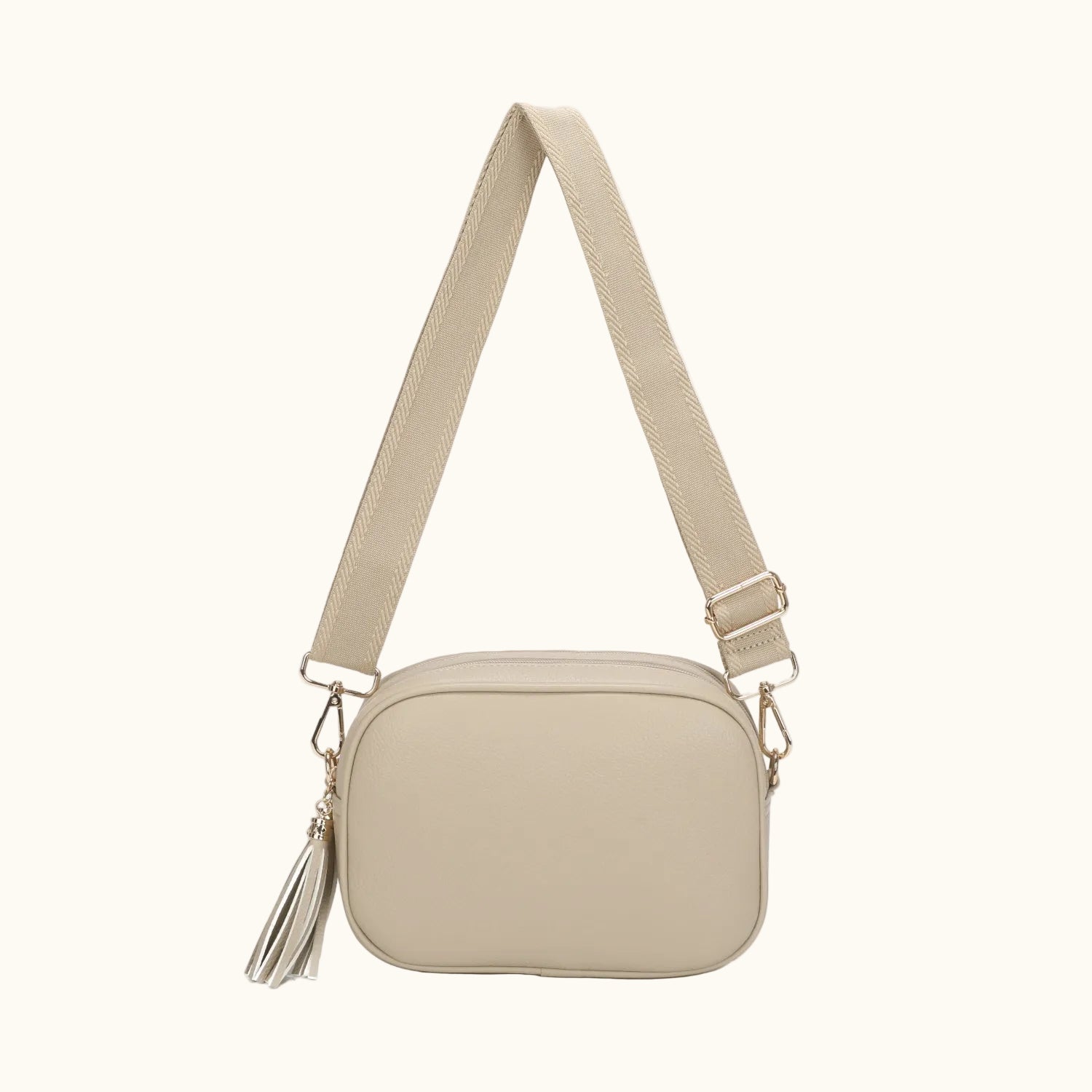 Beige crossbody bag with a strap on a white background
