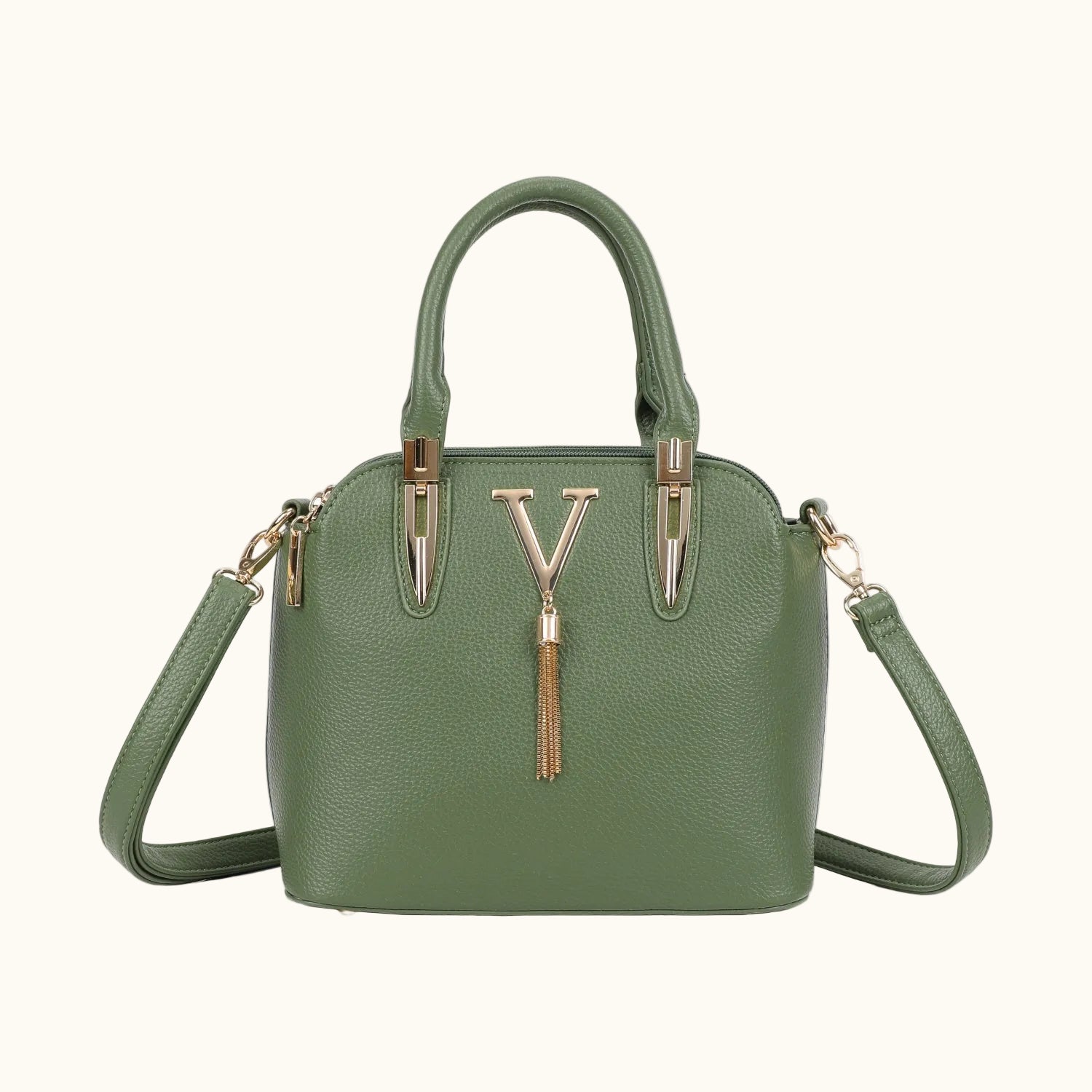 Green handbag with a gold tassel on a white background