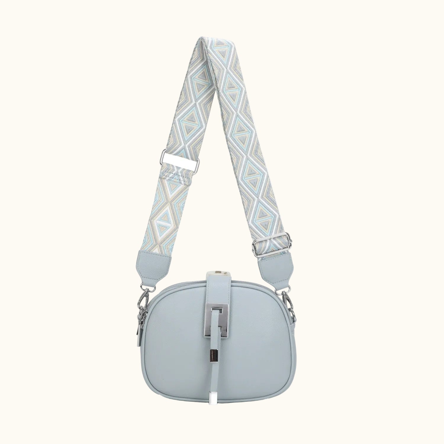Light blue handbag with a patterned strap on a white background