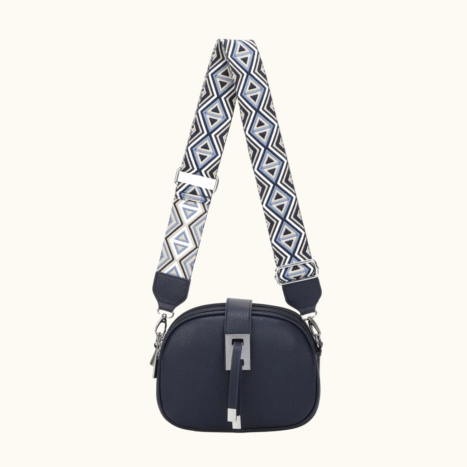 Navy blue handbag with a patterned strap on a white background