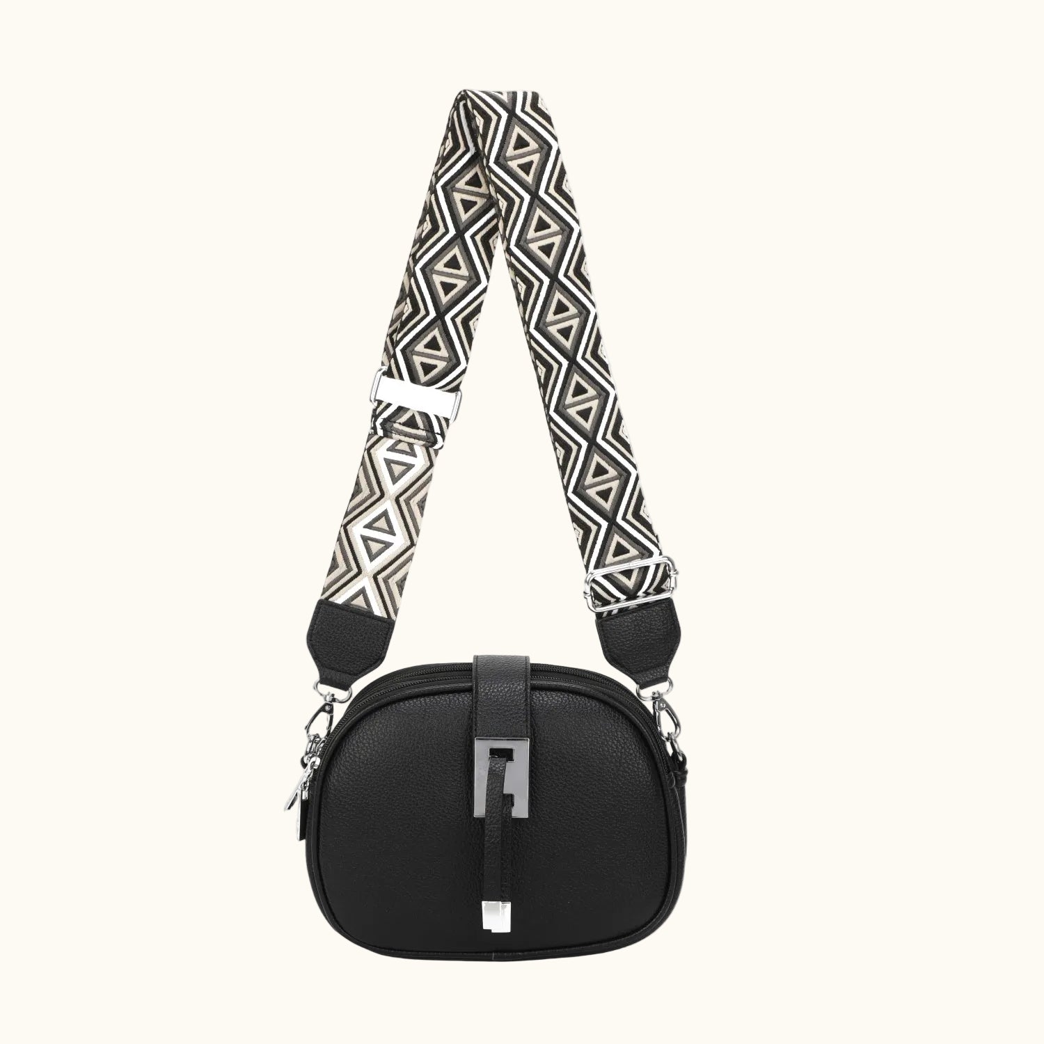 Black handbag with a patterned strap on a white background