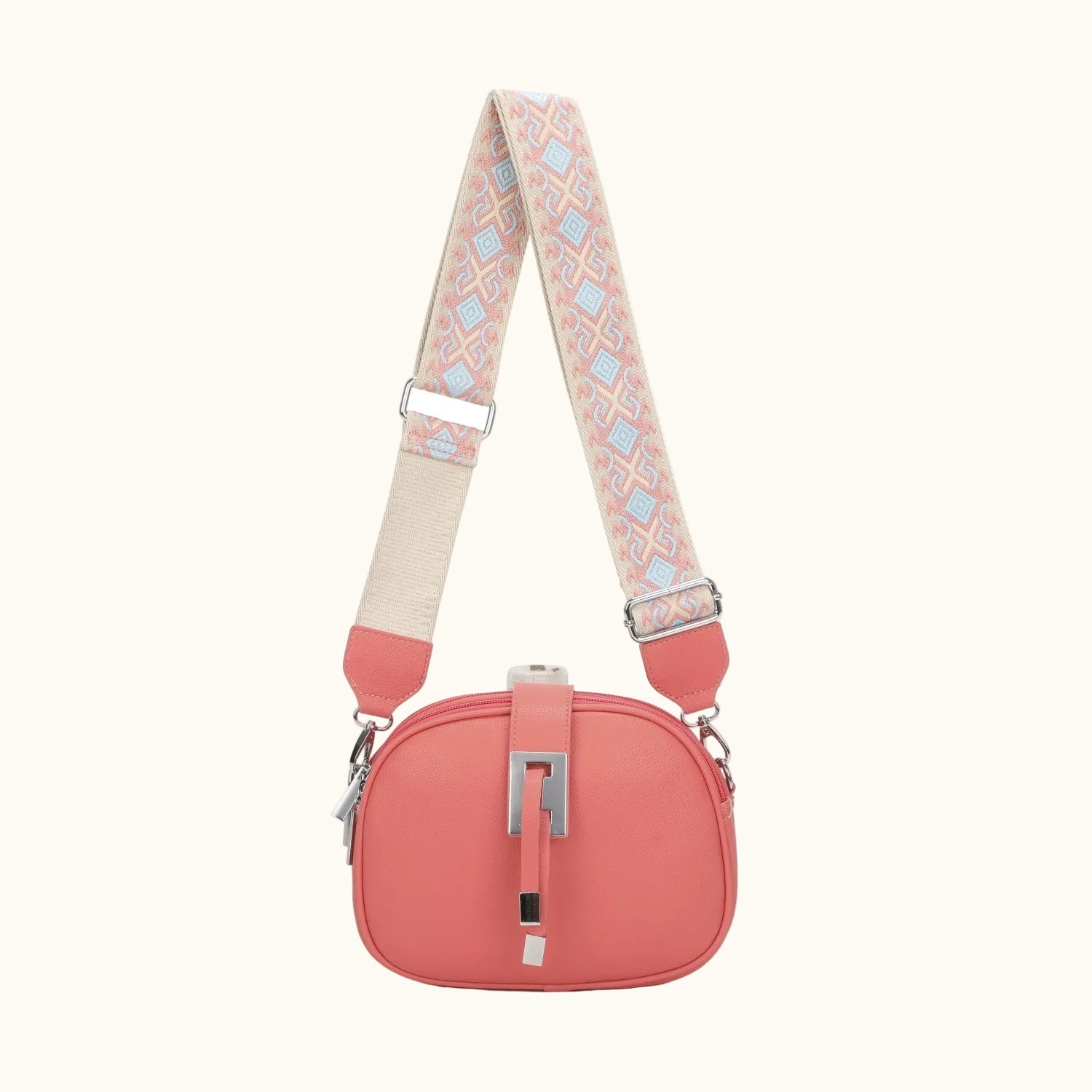 Coral handbag with a patterned strap on a white background
