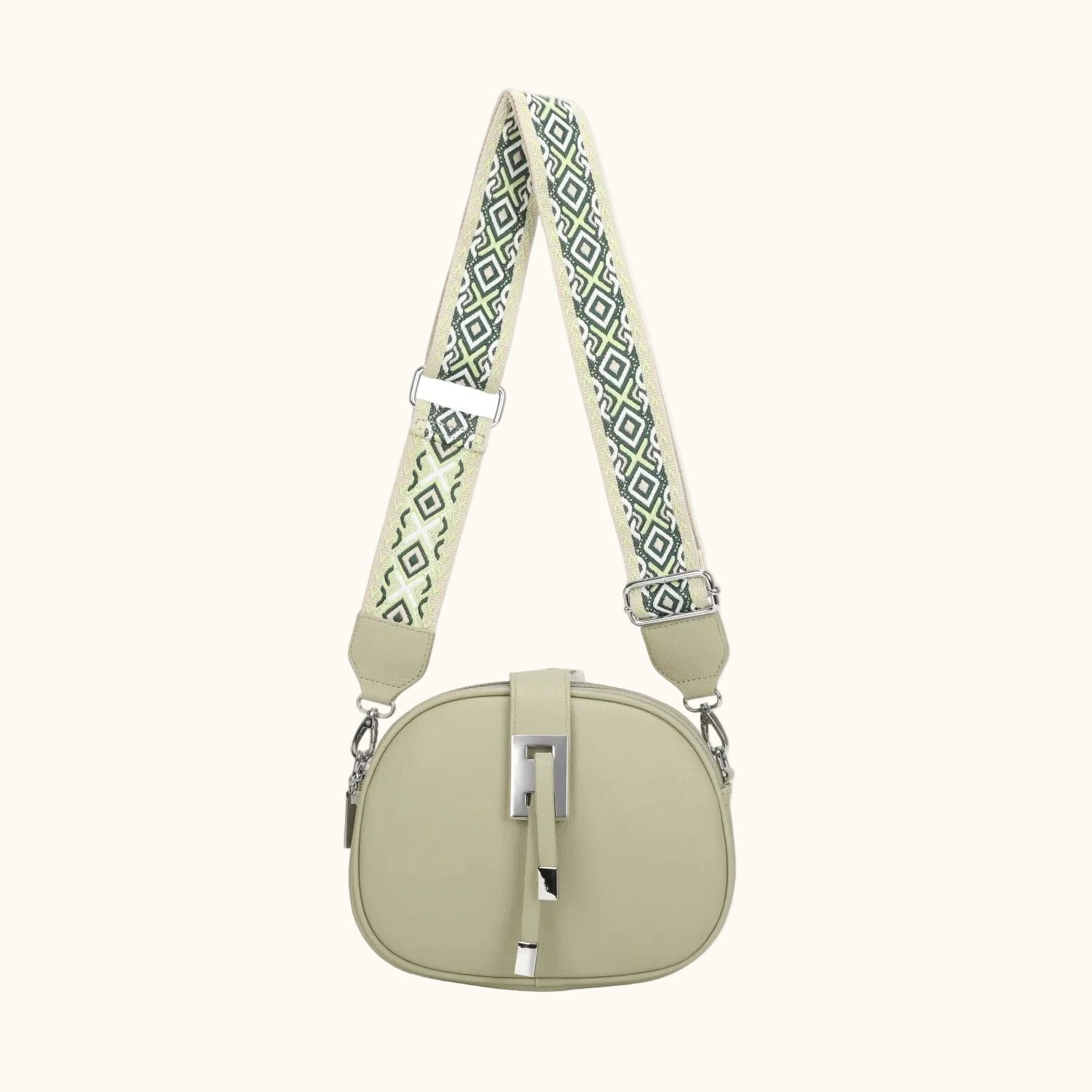 Light green circular bag with a patterned strap on a white background