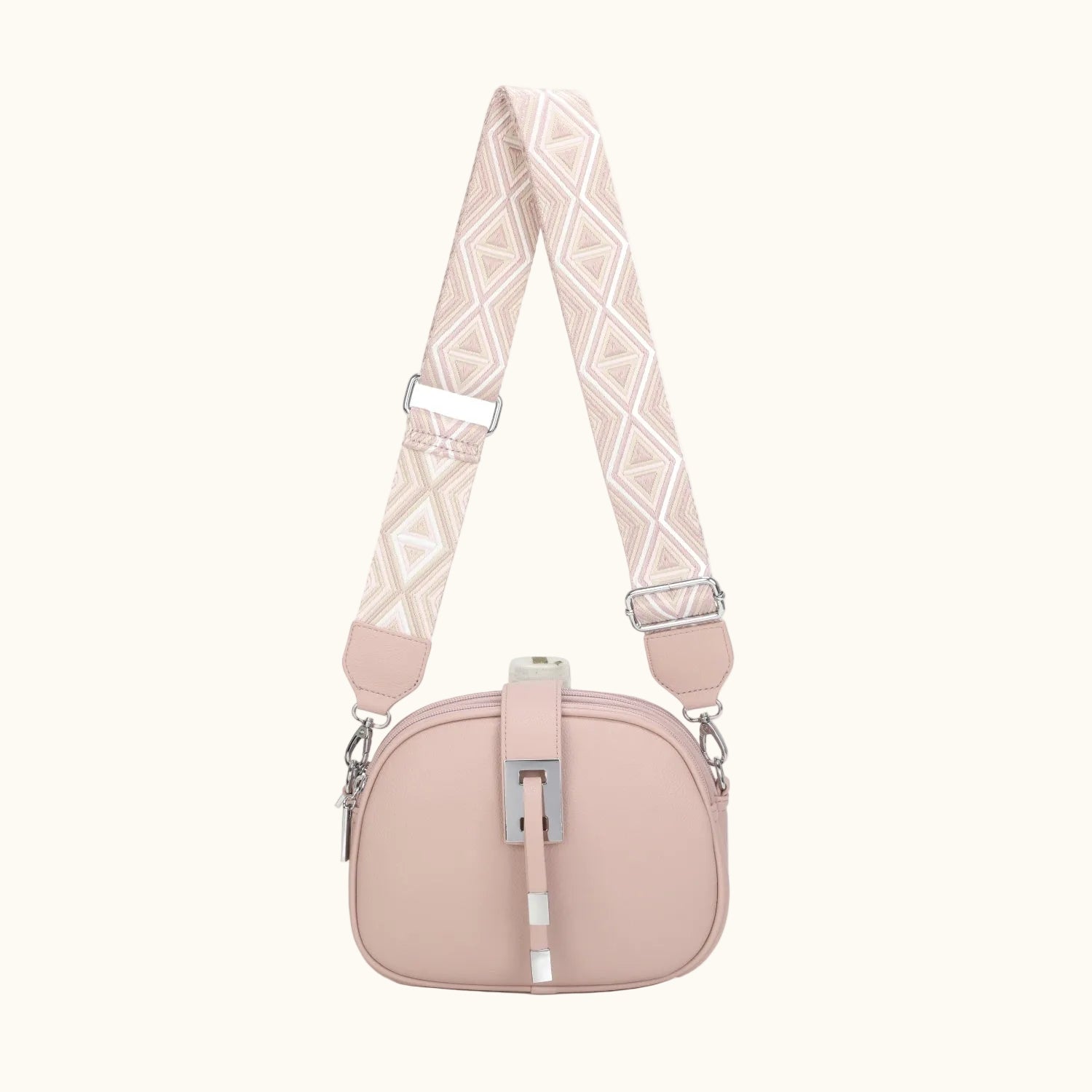 Pink handbag with a patterned strap on a white background