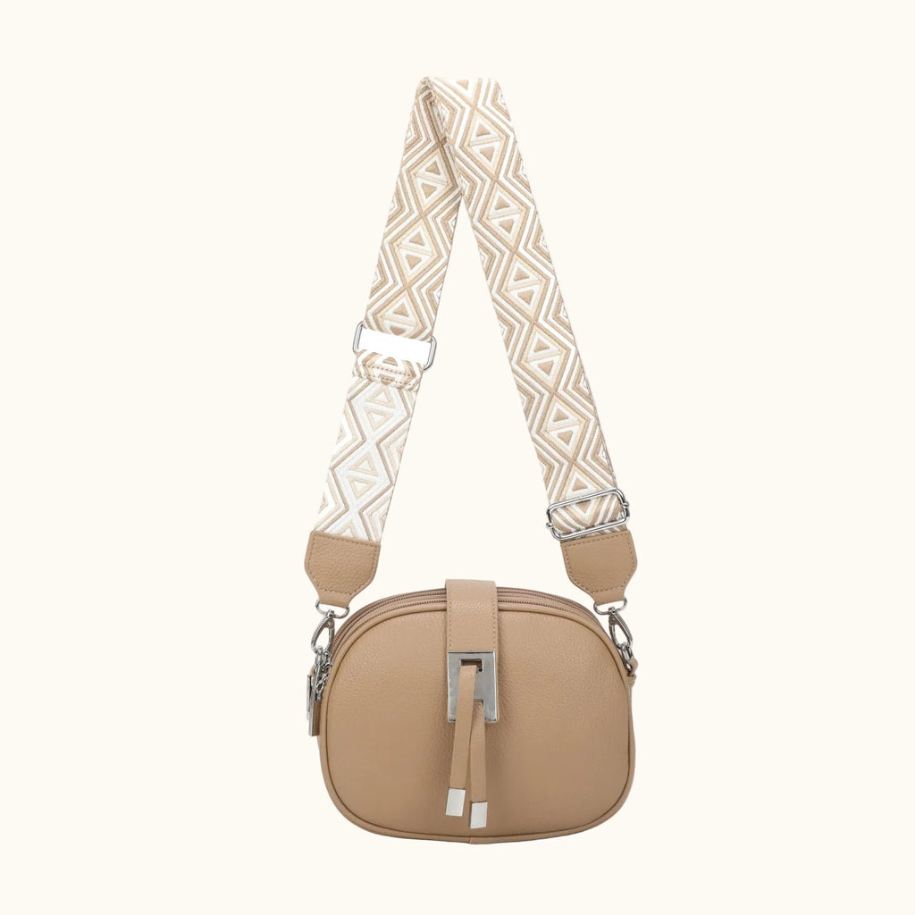 Beige handbag with a patterned strap on a white background