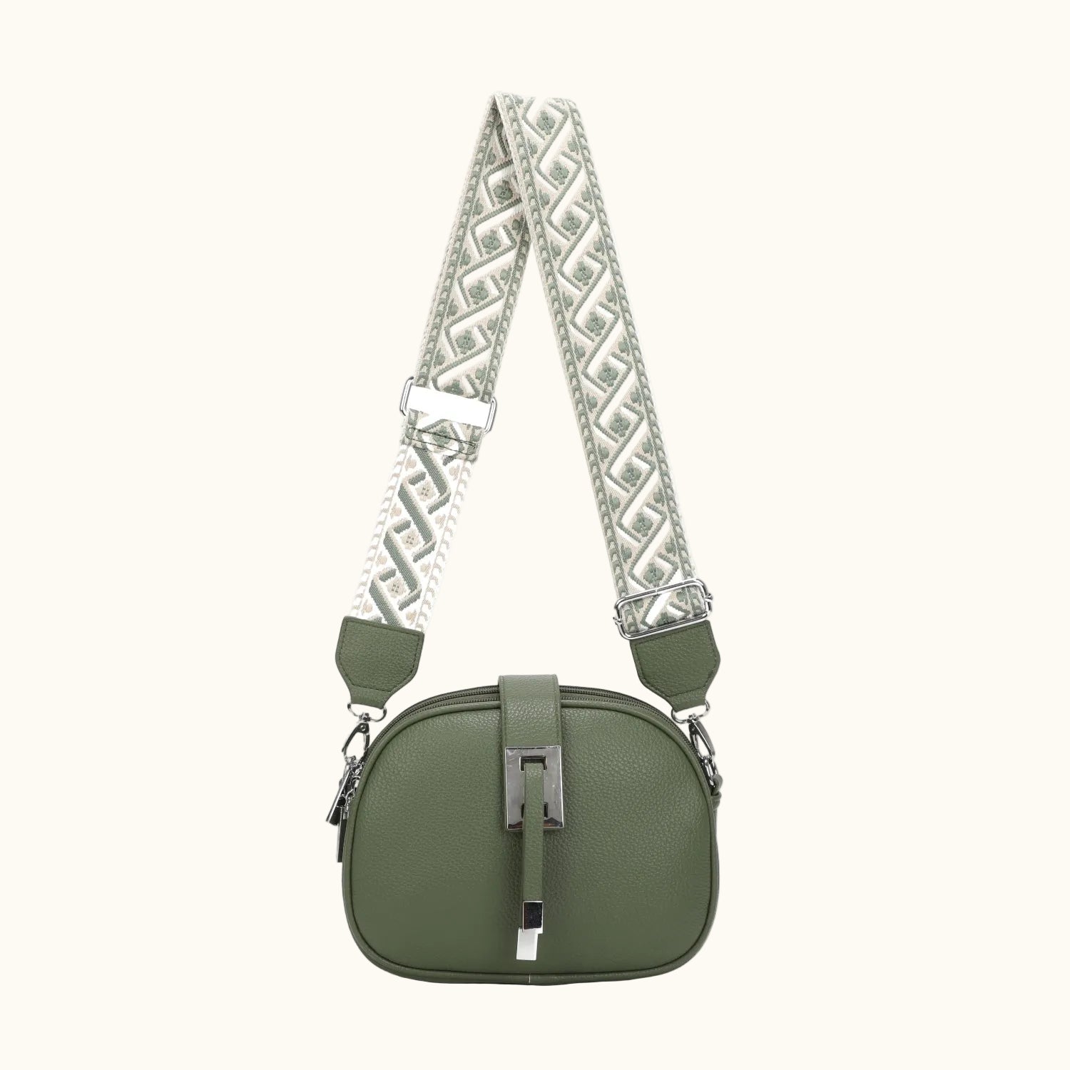 Green handbag with a patterned strap on a white background