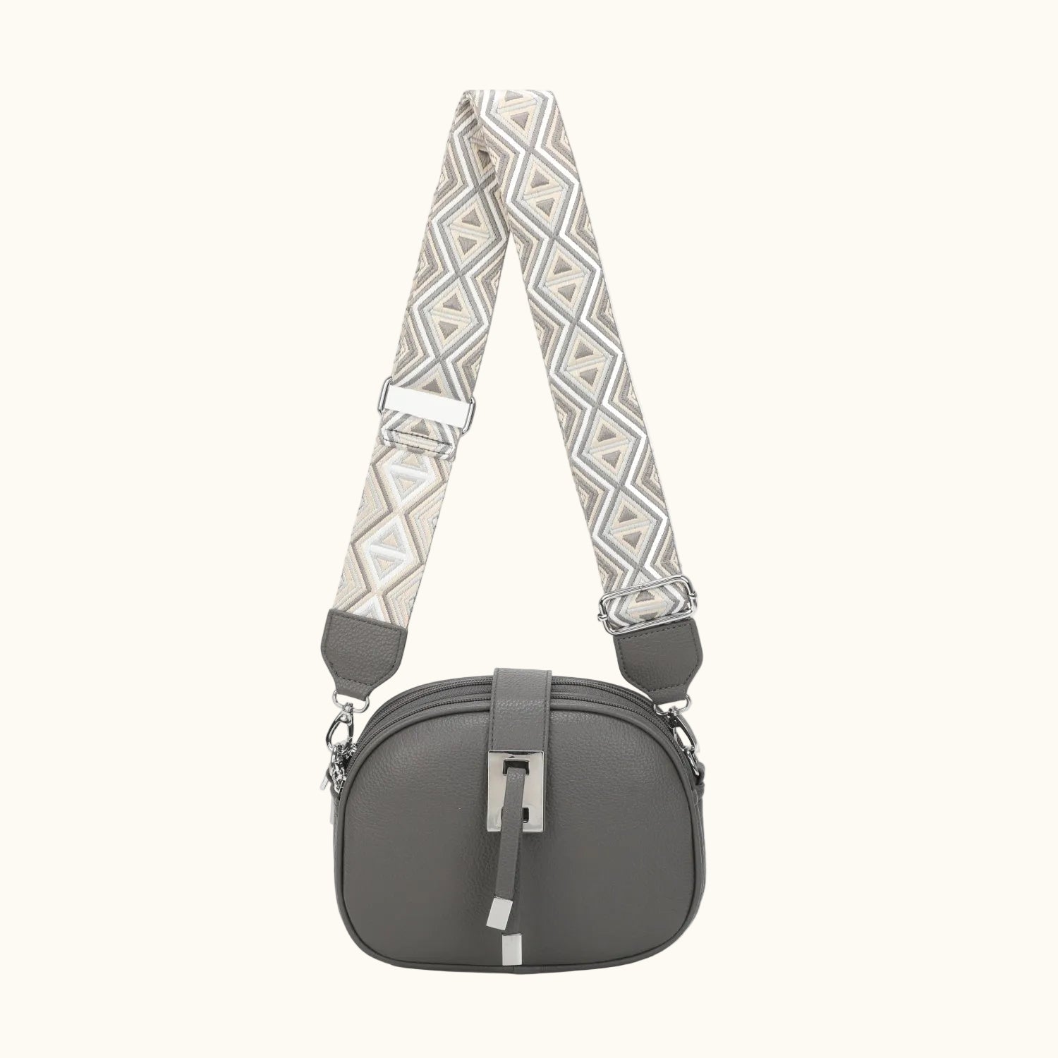 Gray handbag with a patterned strap on a white background