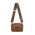 Brown leather bag with a patterned strap on a white background
