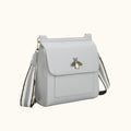 Gray handbag with a bee emblem on a white background