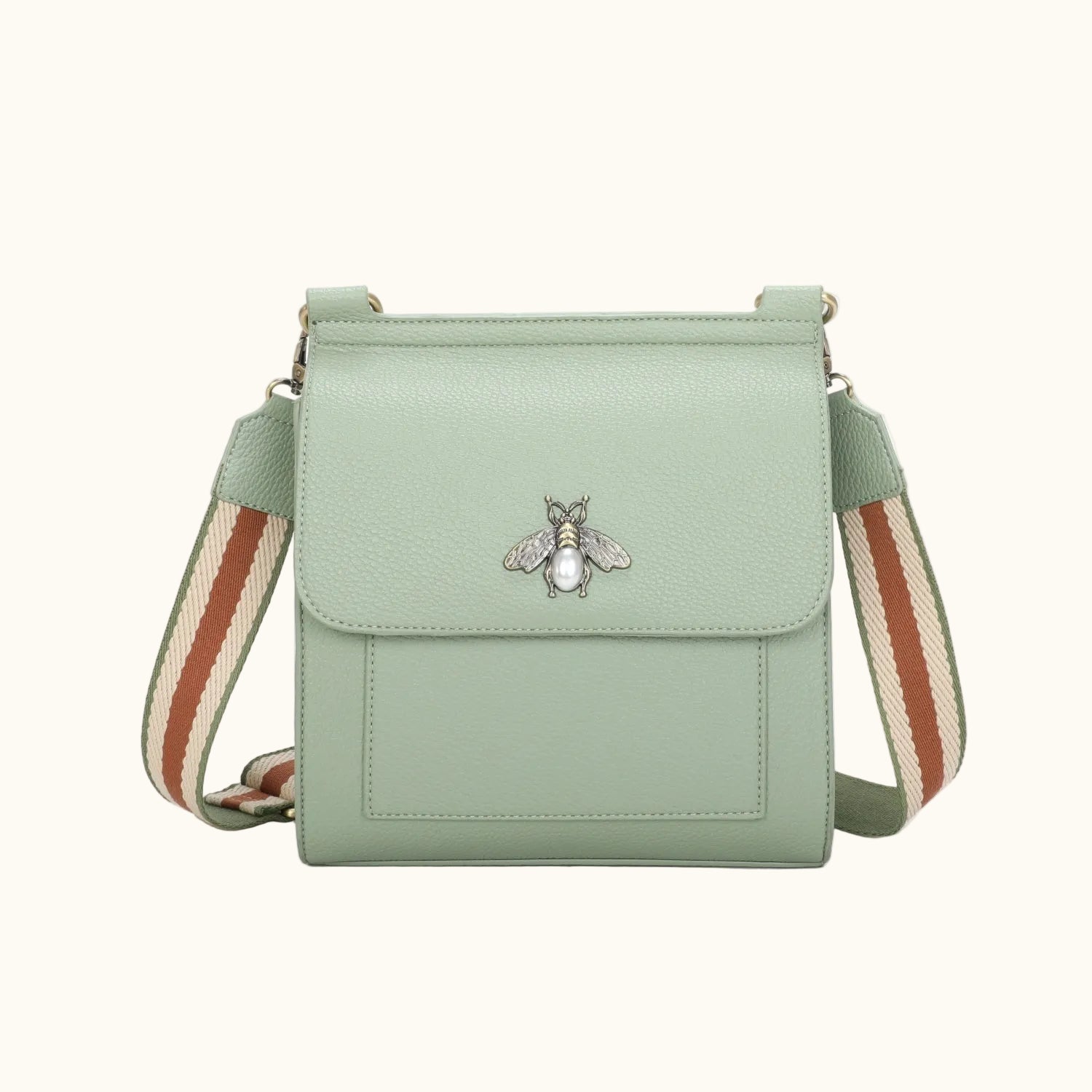 Mint green crossbody bag with a bee emblem on a white background