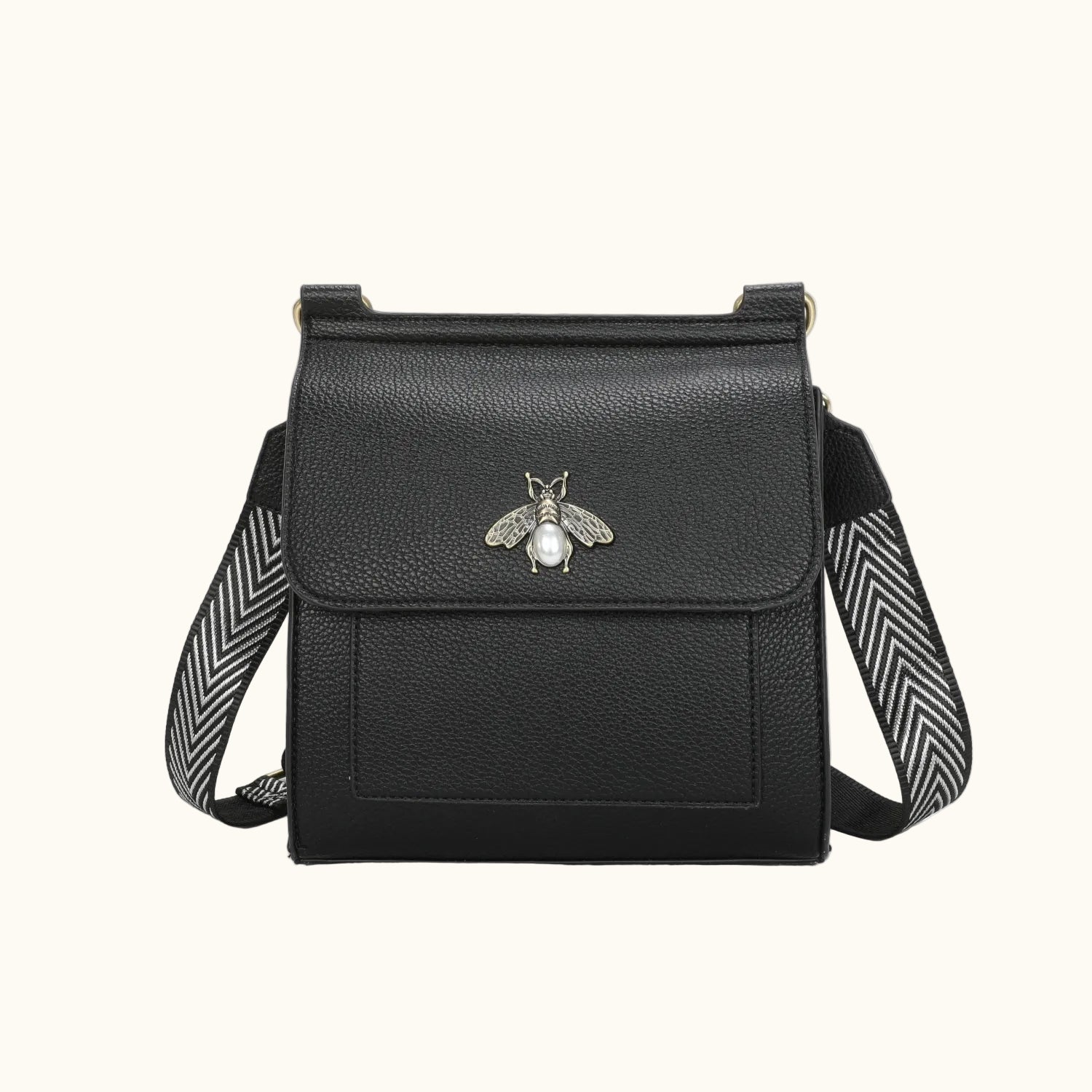Black leather crossbody bag with bee emblem on a white background