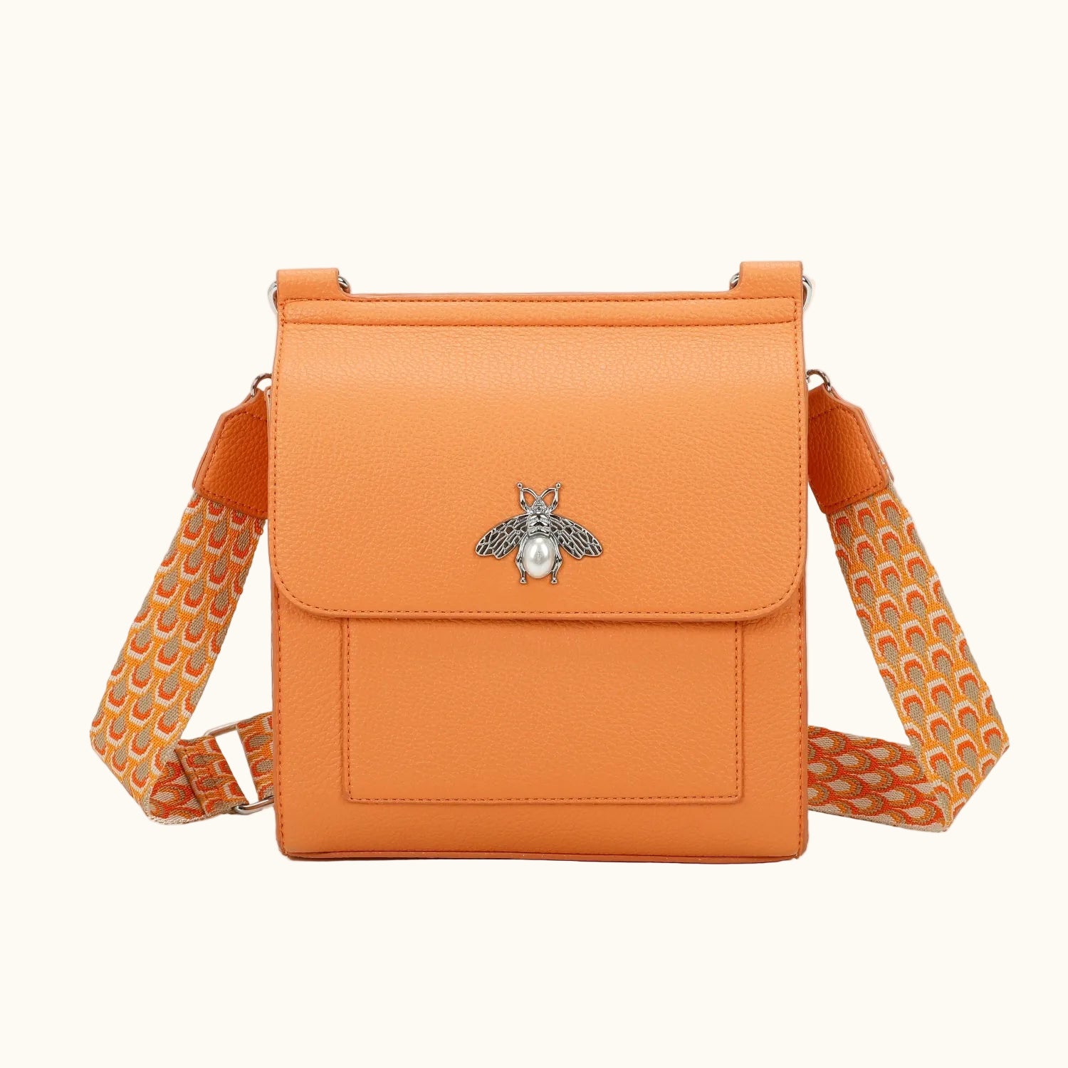 Orange crossbody bag with a bee emblem on a white background