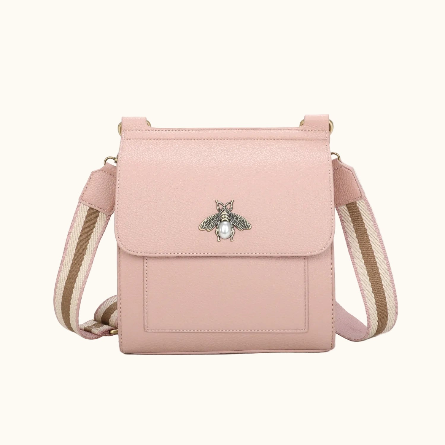 Pink crossbody bag with a bee emblem on a white background