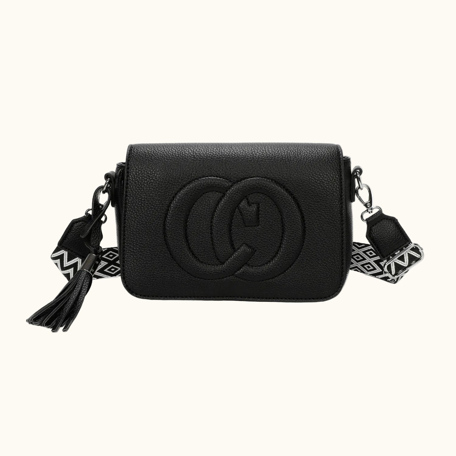Black handbag with a decorative strap on a white background