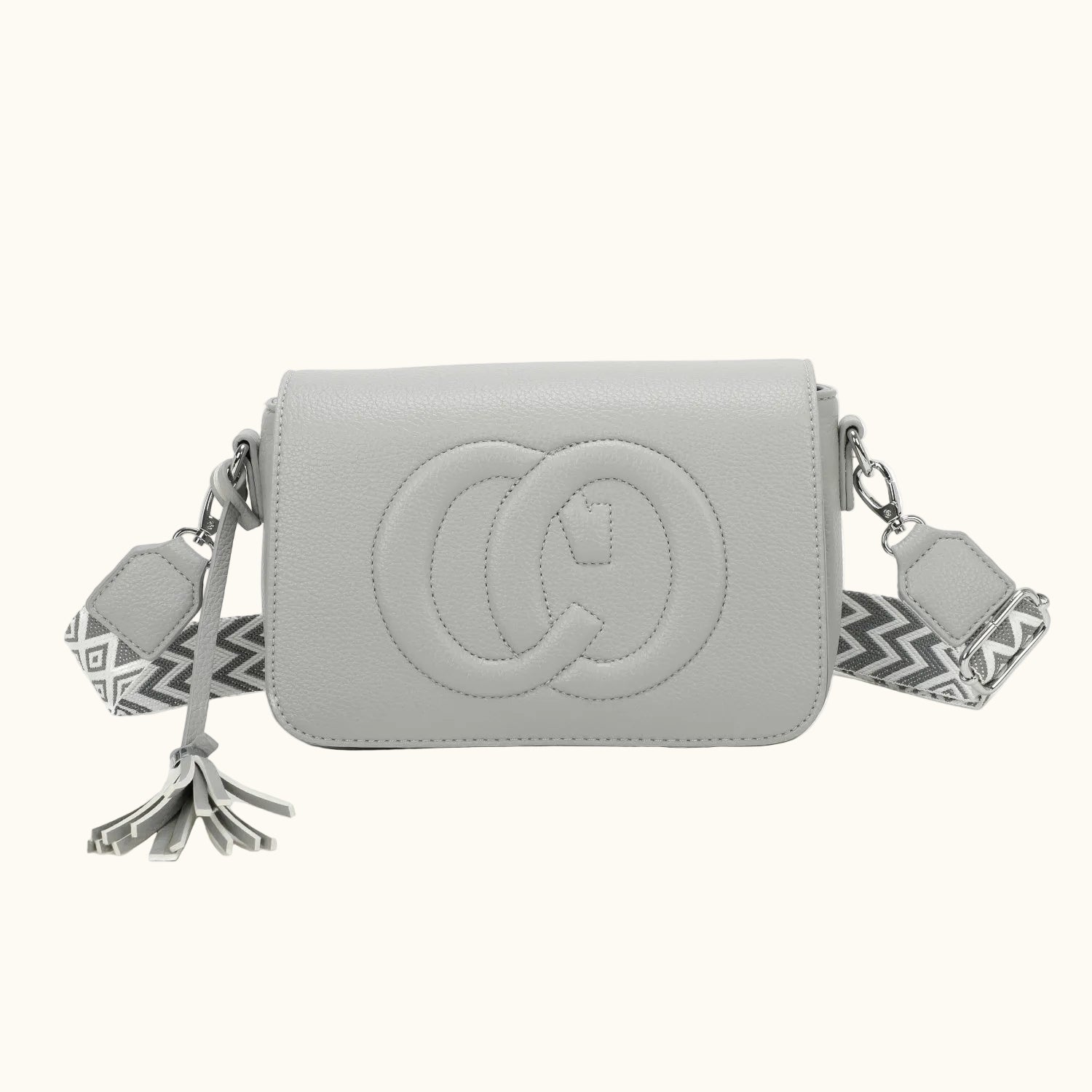 Gray handbag with a decorative strap on a white background