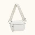 White handbag with a patterned strap on a white background