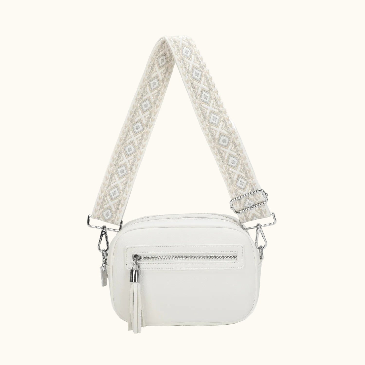White handbag with a patterned strap on a white background