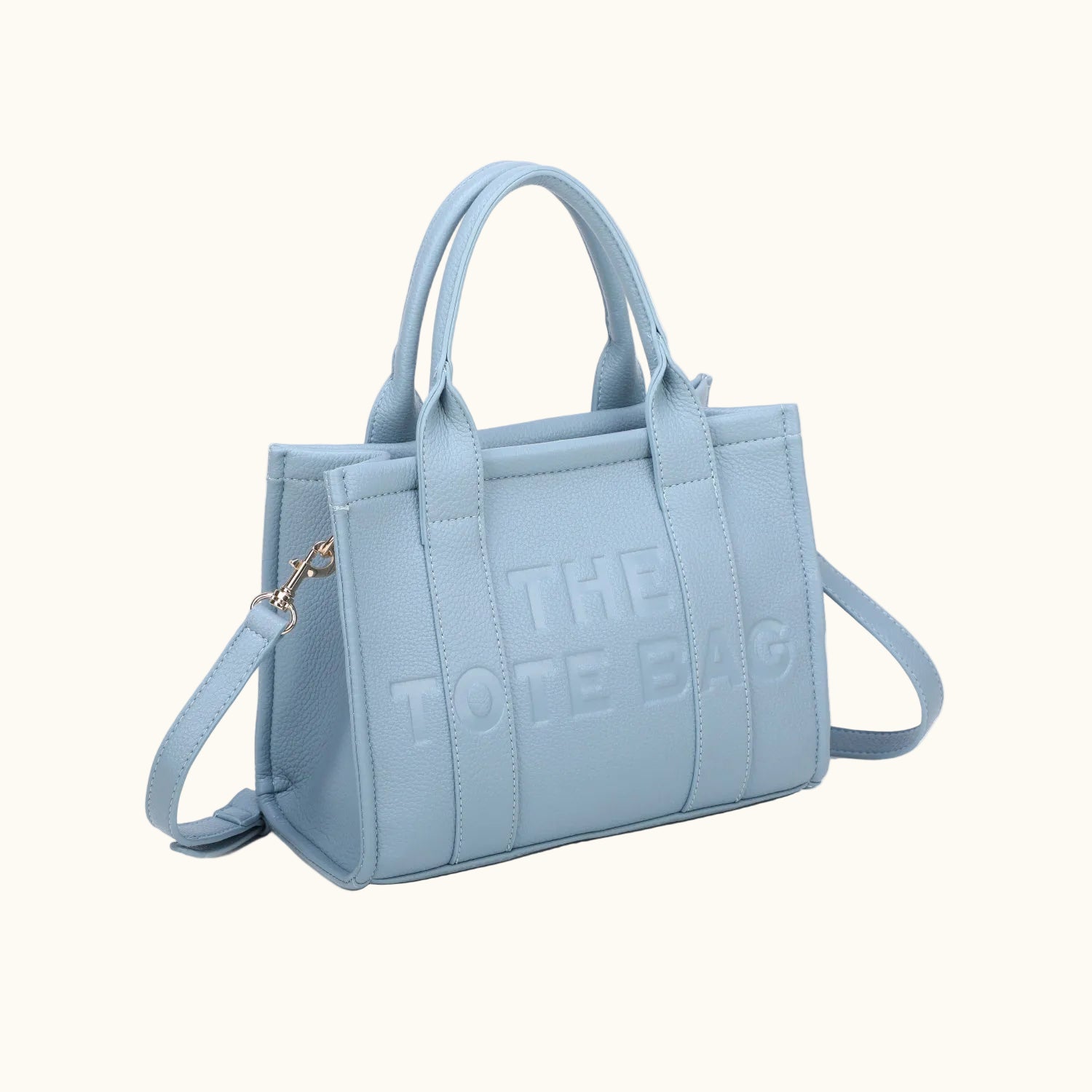 Light blue handbag with 'THE DOLE BAG' text on a white background