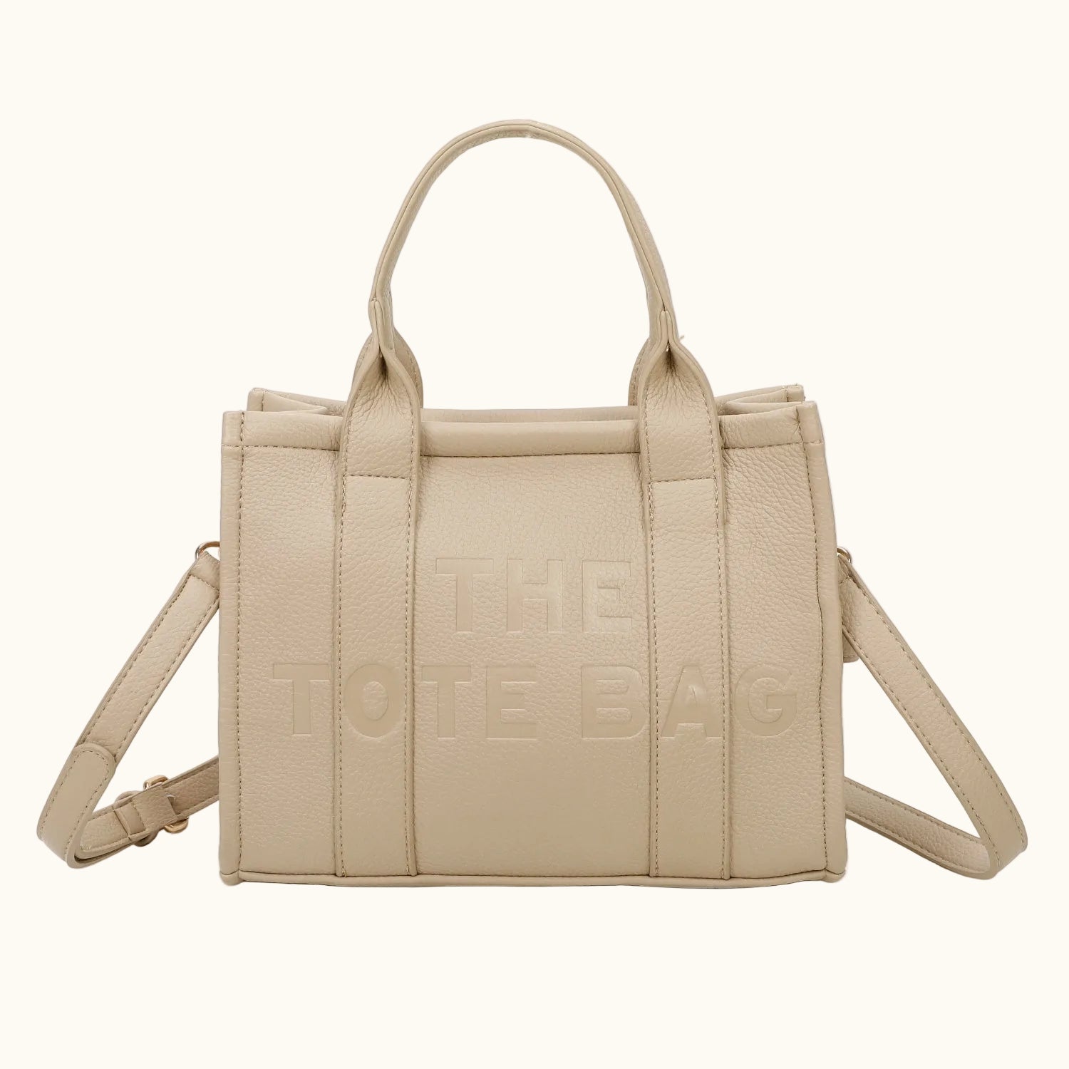 Beige handbag with 'THE TOTE BAG' text on a white background