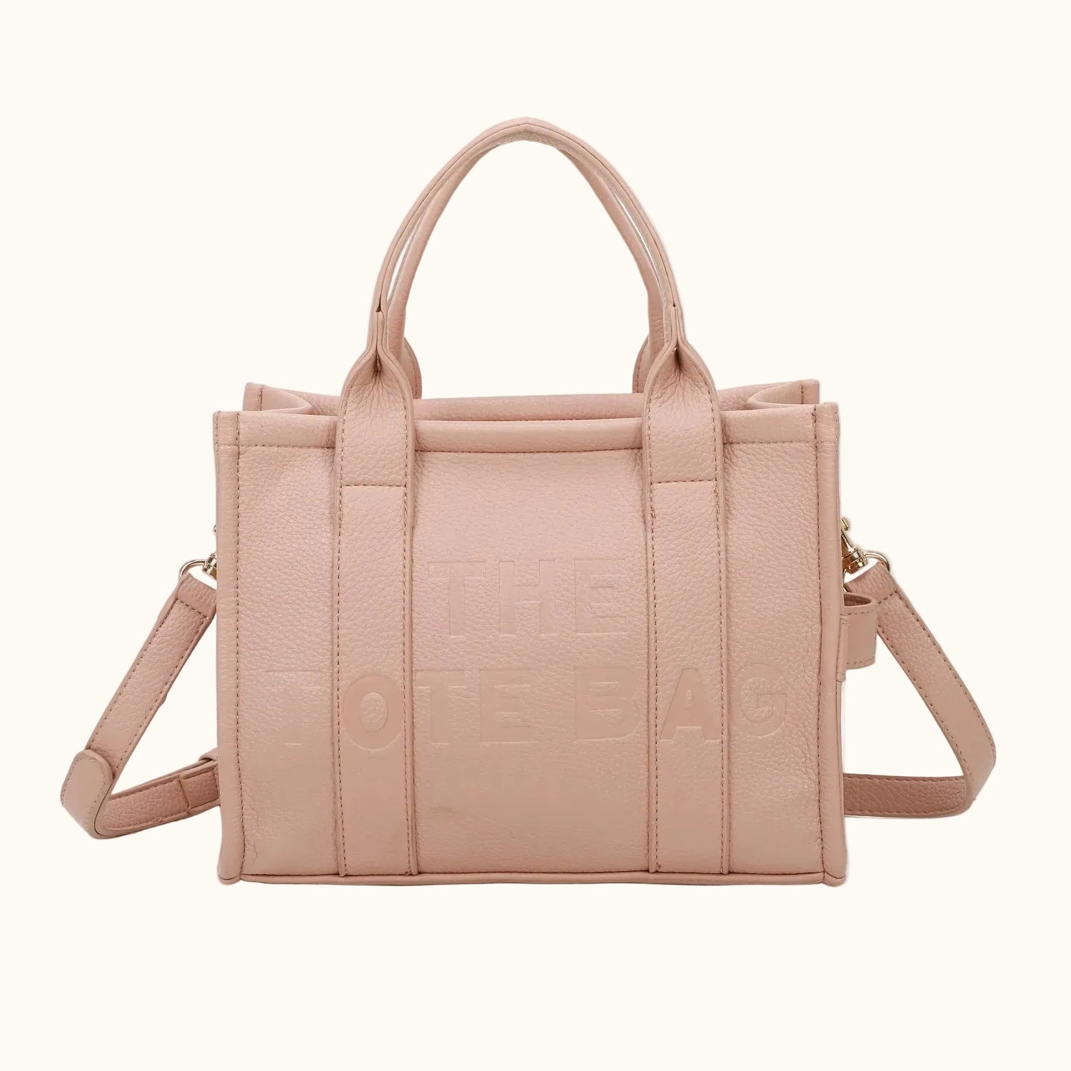 Pink handbag with a strap on a white background