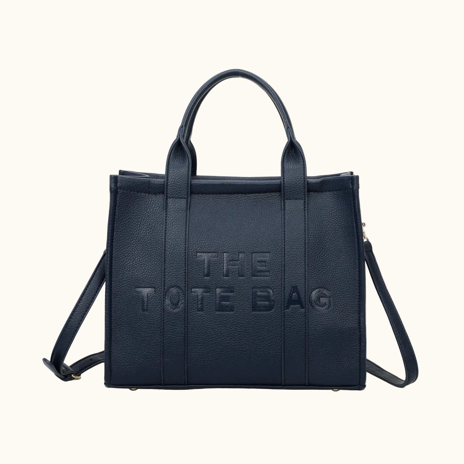 Black tote bag with 'THE TOTE BAG' text on a white background