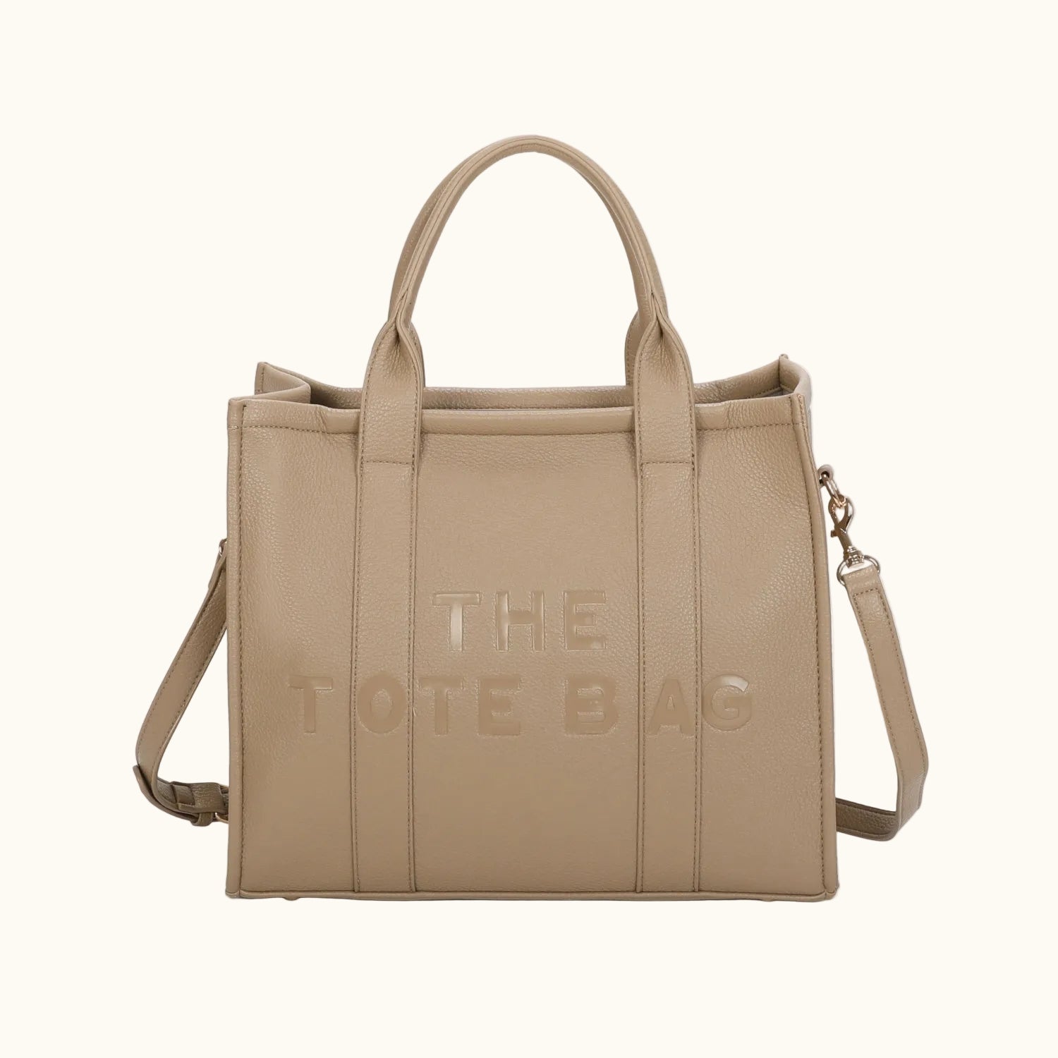 Beige tote bag with 'THE TOTE BAG' text on a white background
