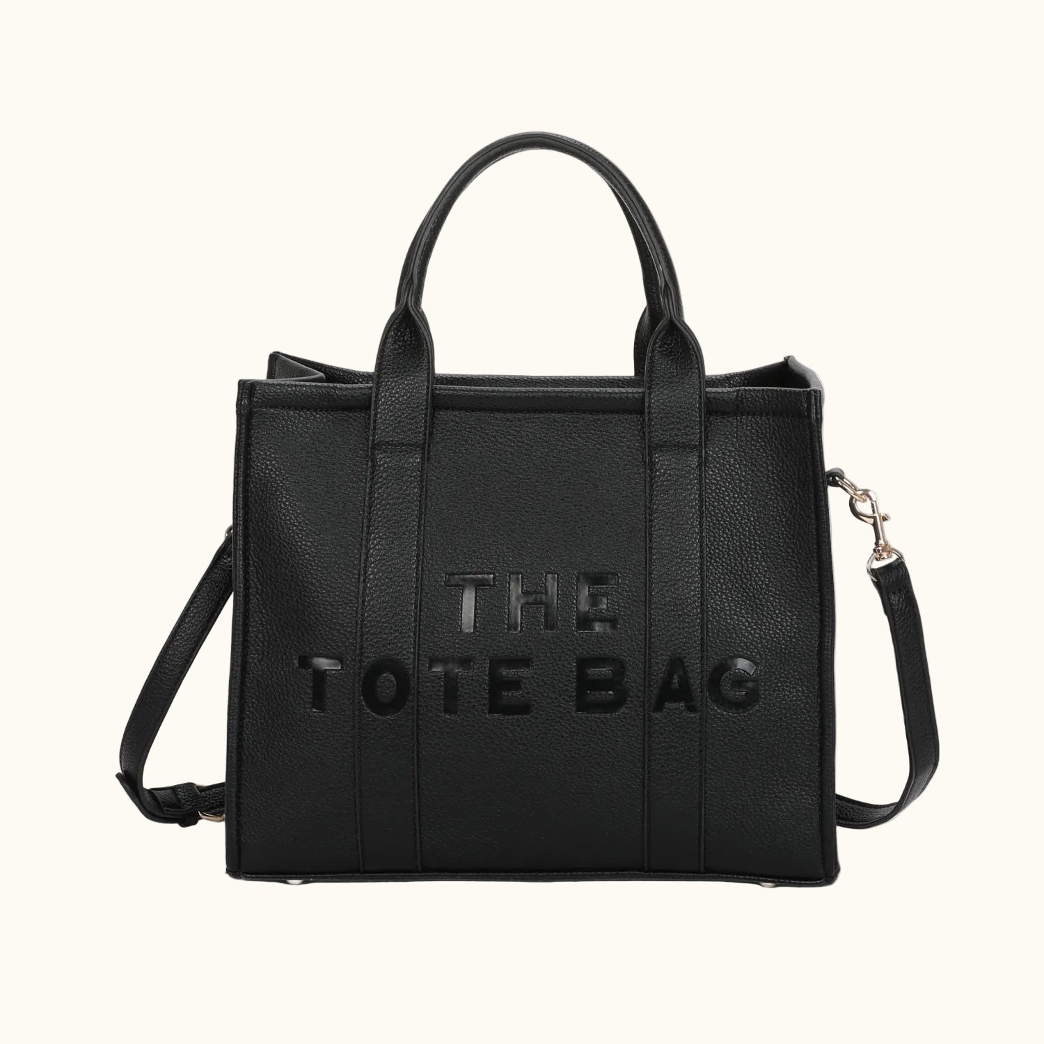 Black tote bag with 'THE TOTE BAG' text on a white background