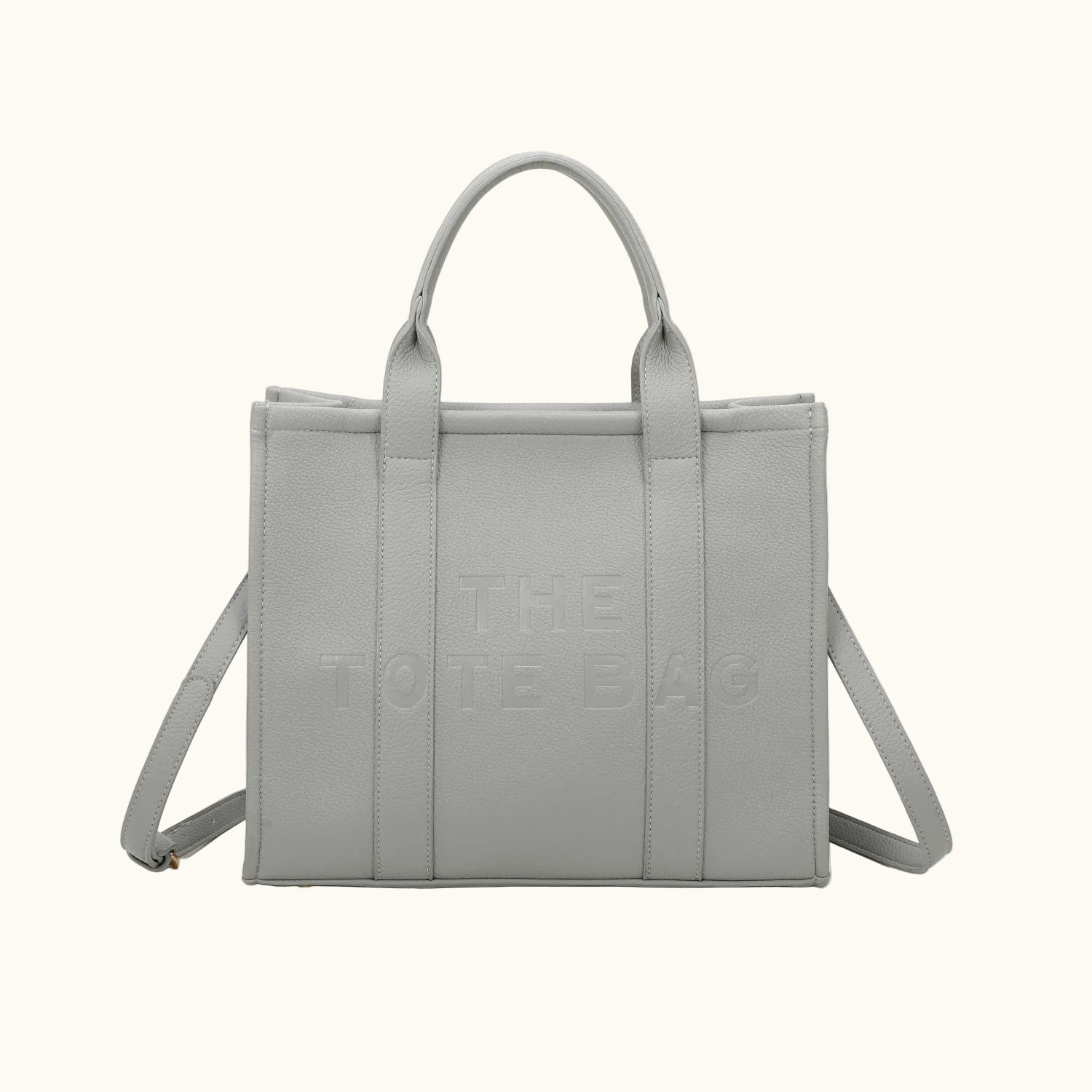 Gray tote bag with 'The Tote Bag' text on a white background