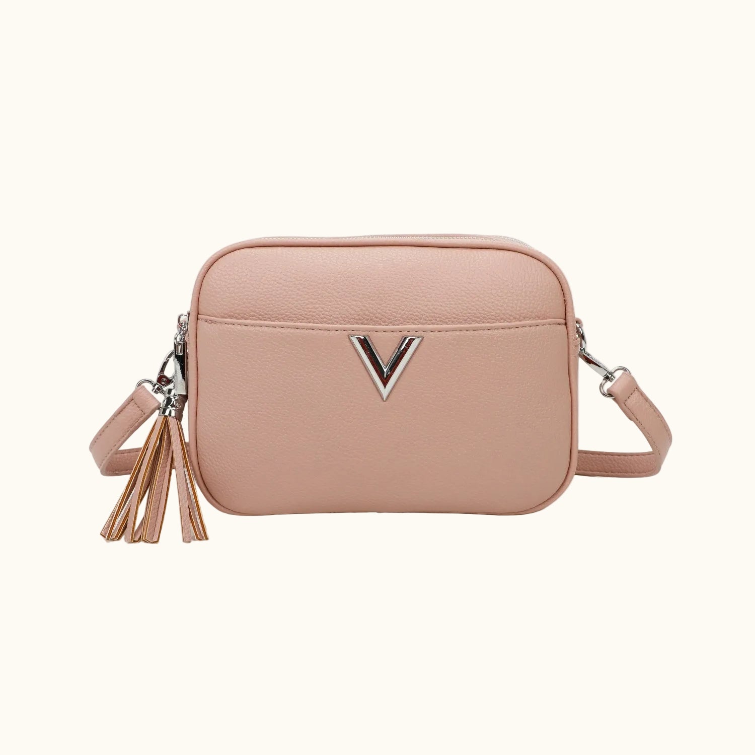 Pink crossbody bag with a tassel on a white background