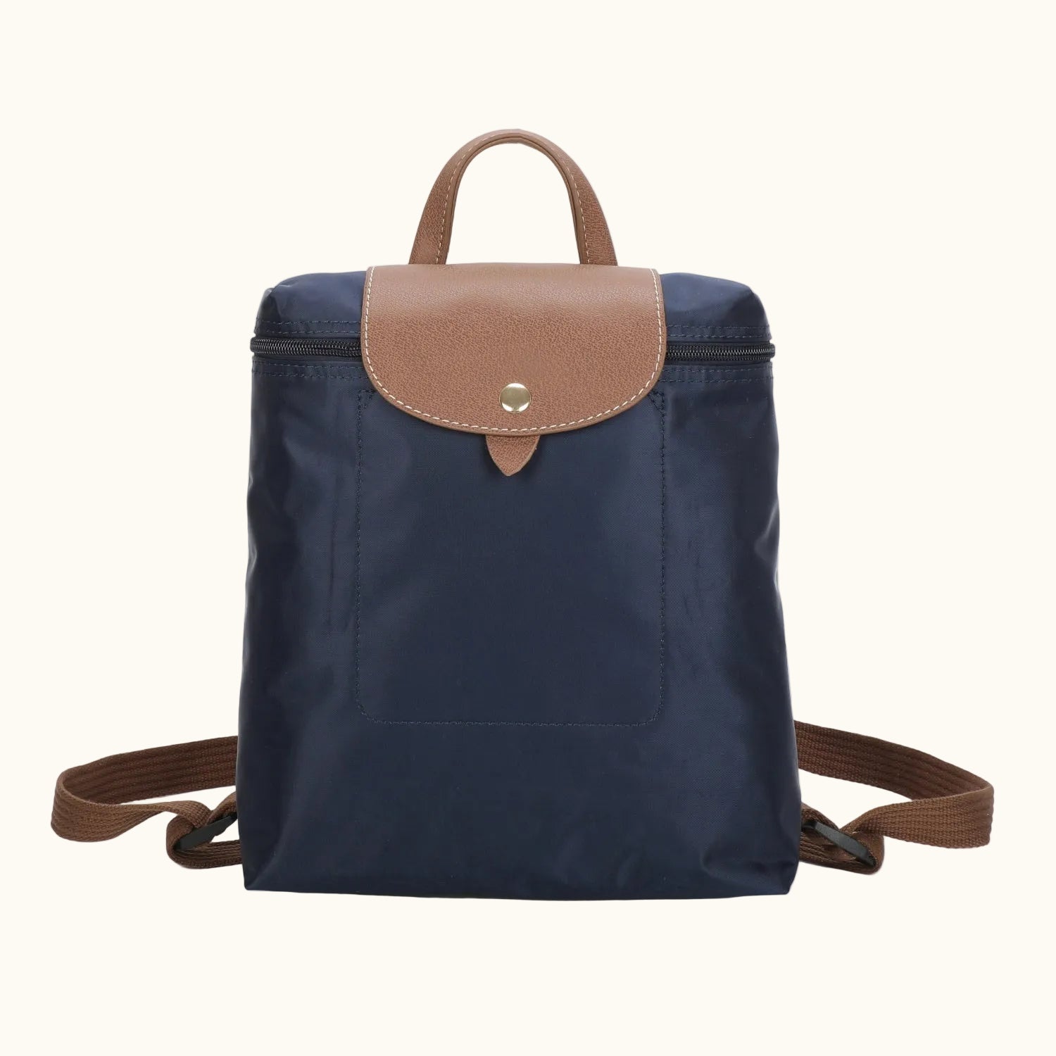 Navy blue backpack with brown leather accents on a white background