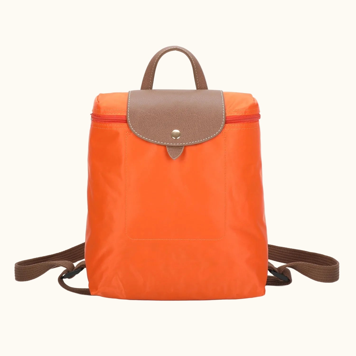 Orange backpack with brown leather accents on a white background
