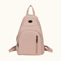 Pink backpack with zippers on a white background