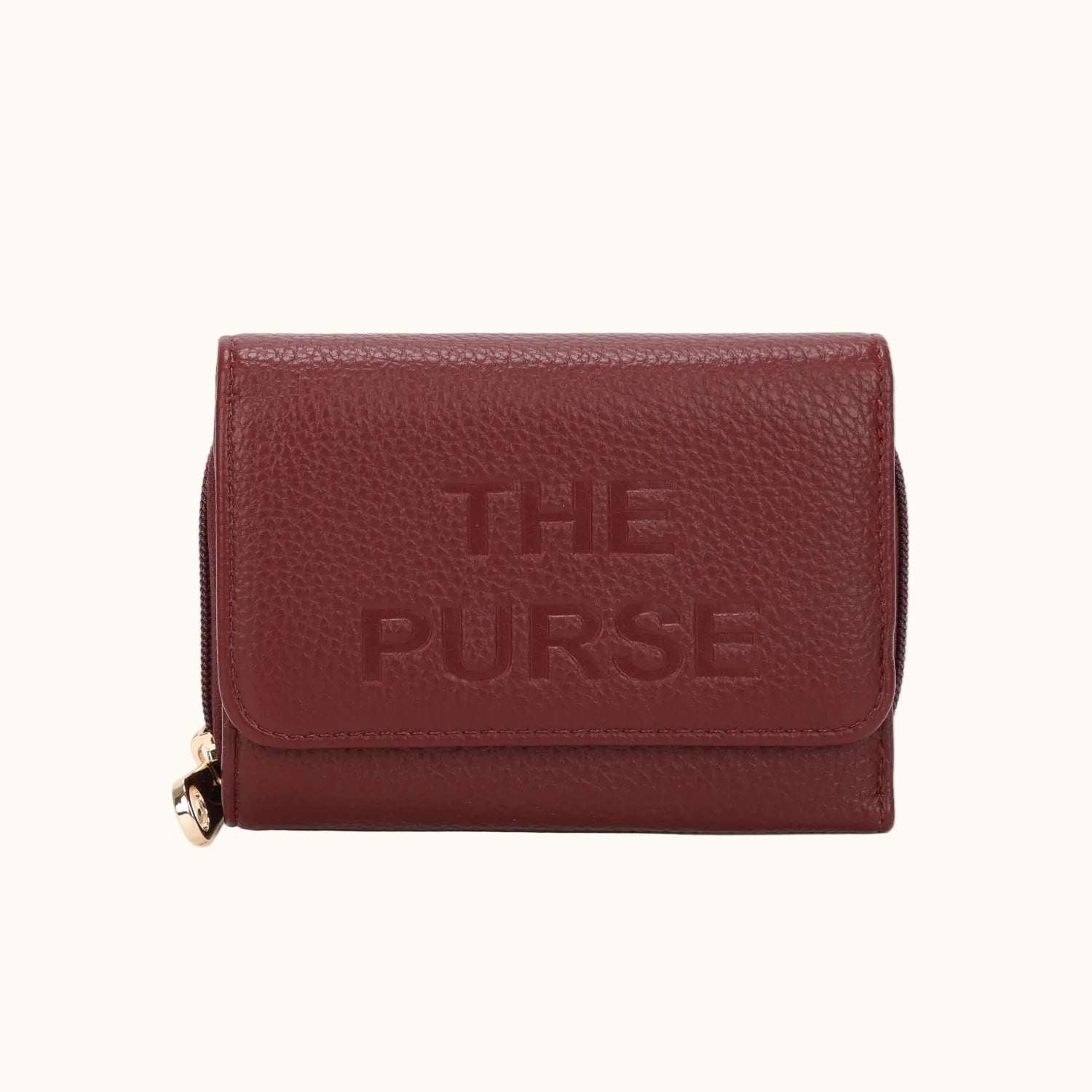 Brown leather wallet with 'THE PURSE' embossed on it against a white background