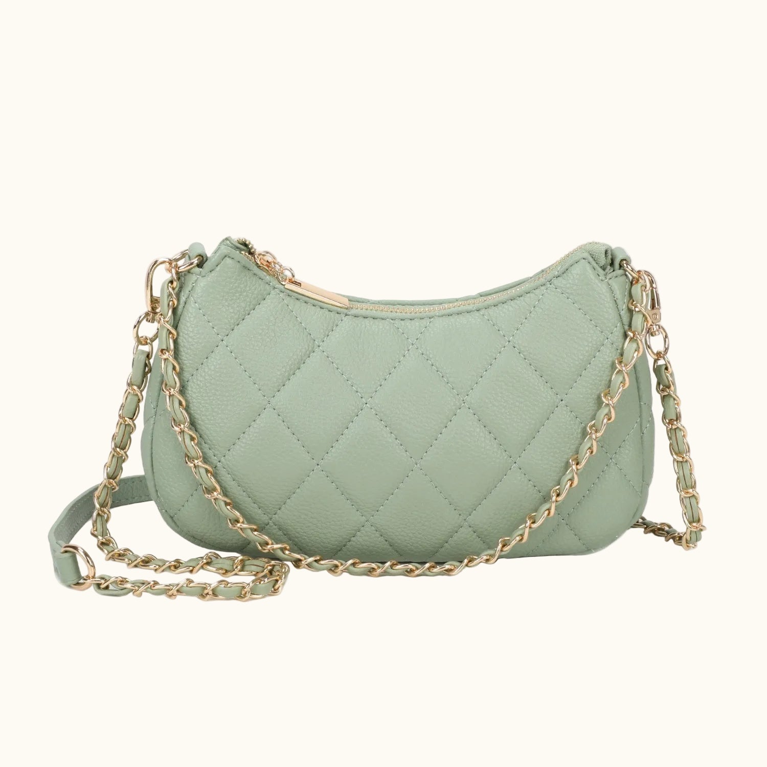 Green quilted handbag with a gold chain on a white background
