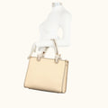Beige handbag on a mannequin with a white background