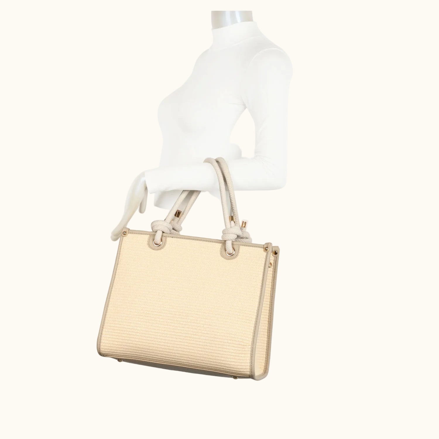 Beige handbag on a mannequin with a white background
