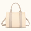 Beige handbag with woven design on a white background
